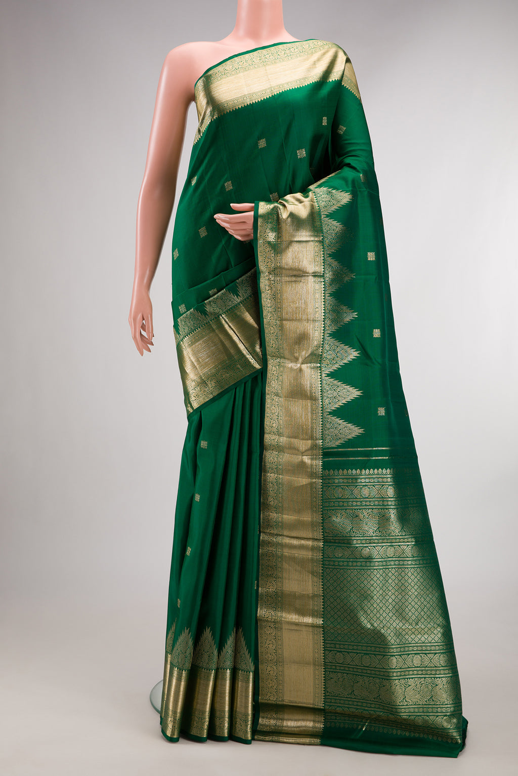 Pure Silk Bottle Green Kanjivaram Saree with Zari Butta on the body and Zari Border.  displayed on a mannequin