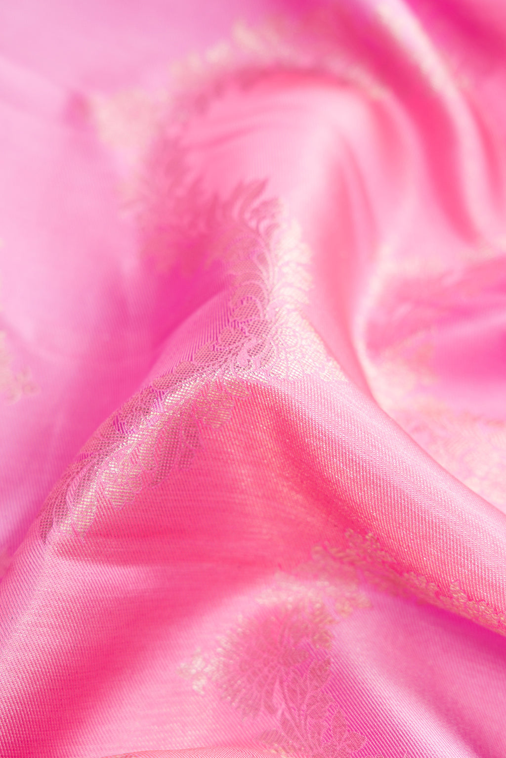 Close up of Pink Dual Tone Kanjivaram Silk Saree with Zari Brocade on the body and Zari Border.  displaying folds
