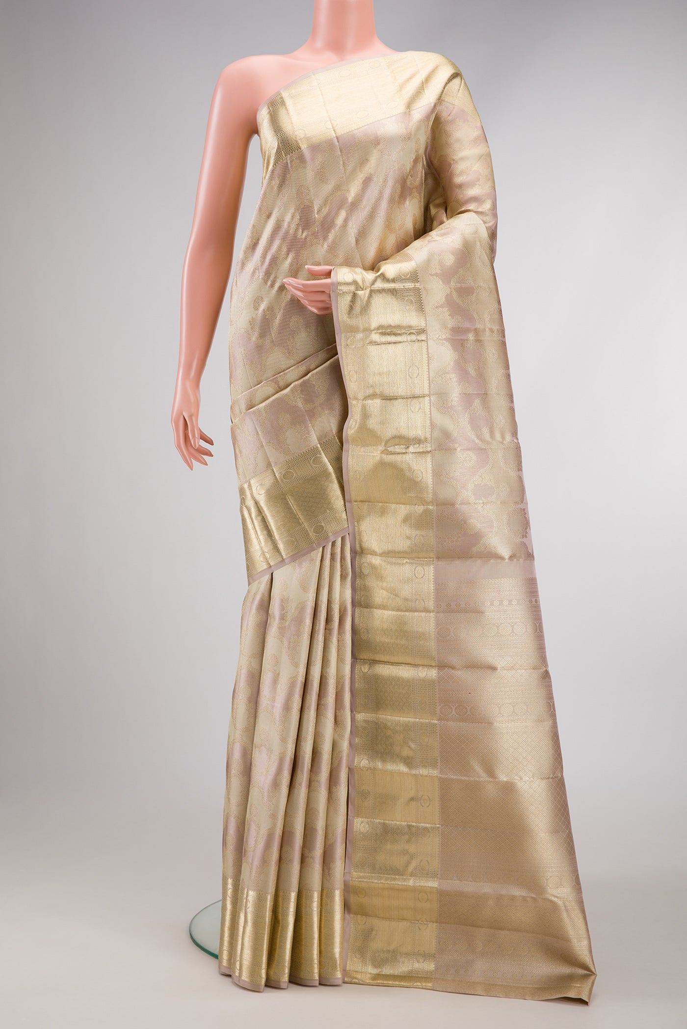 Rose Gold Dual Tone Kanjivaram Silk Saree with Zari Brocade on the body and Zari Border.  displayed on a mannequin