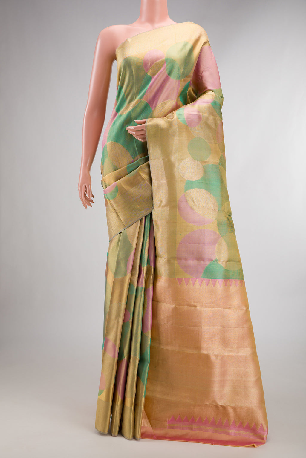 Multi Color Kanjivaram Tissue Saree with Zari Brocade on the body and Zari Border.  displayed on a mannequin
