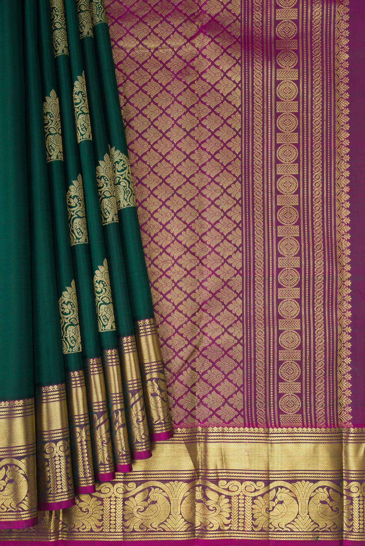Pleats and pallu of Bottle Green Kanjivaram Silk Saree with Zari Butta on the body and Zari Border. 