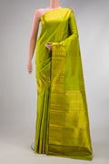 Parrot Green Kanjivaram Silk Saree with Zari Butta on the body and Zari Border.  displayed on a mannequin