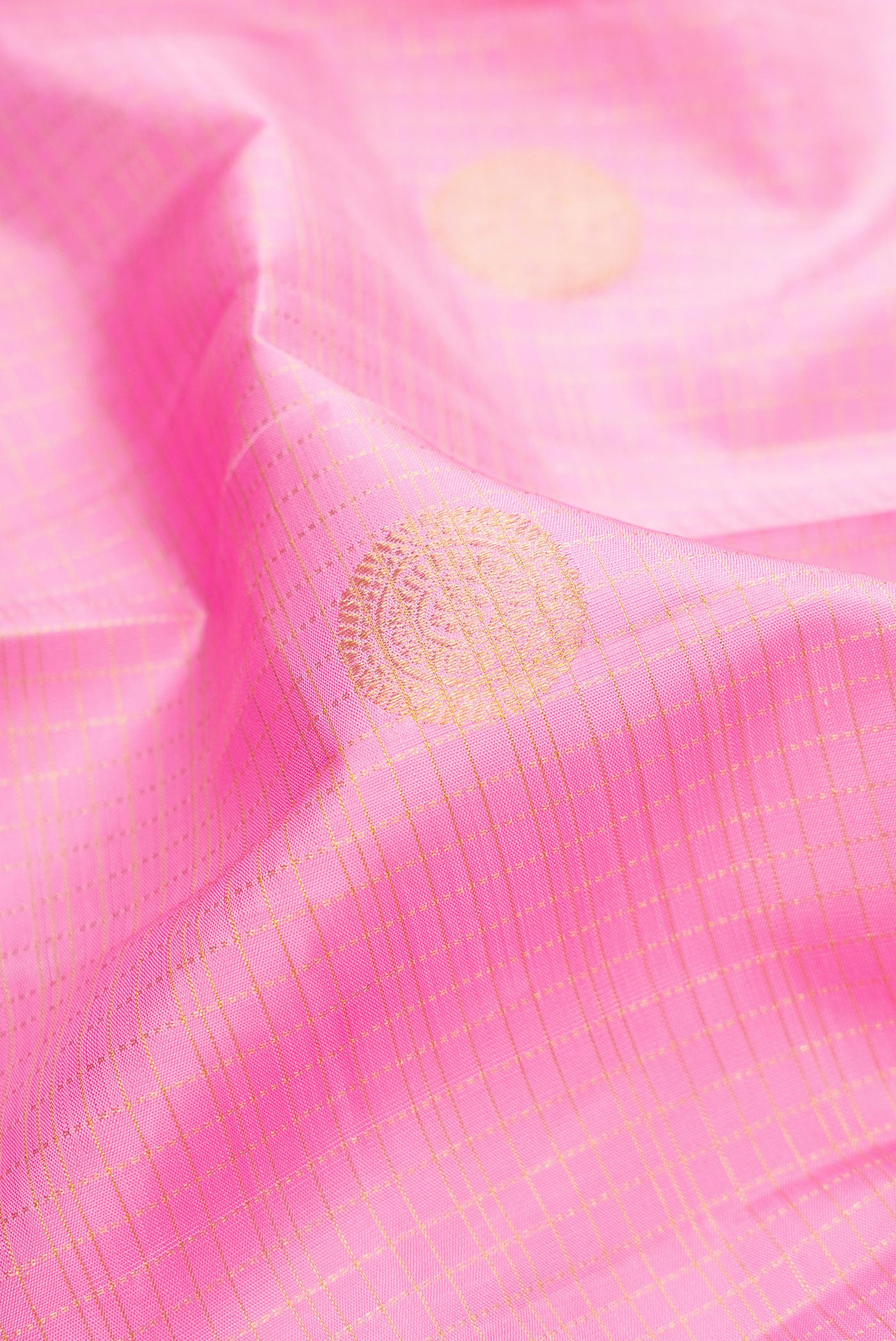 Close up of Pink Dual Tone Kanjivaram Silk Saree with Checked design on the body and Zari Border.  displaying folds