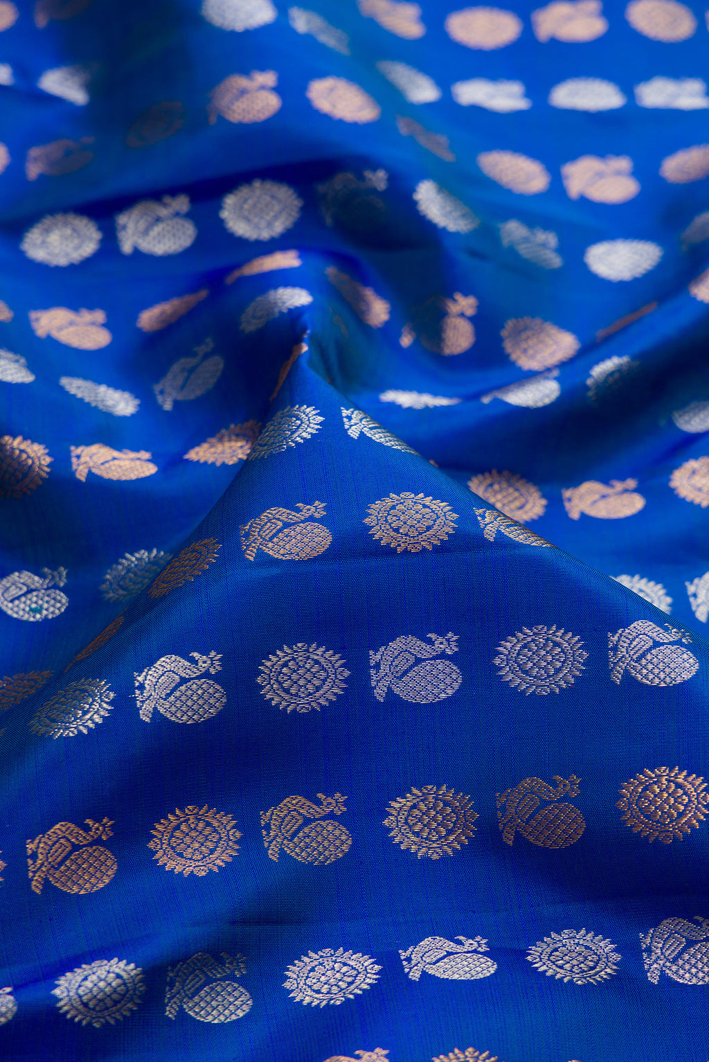 Close up of Royal Blue Kanjivaram Silk Saree with Zari Butta on the body and Zari Border.  displaying folds