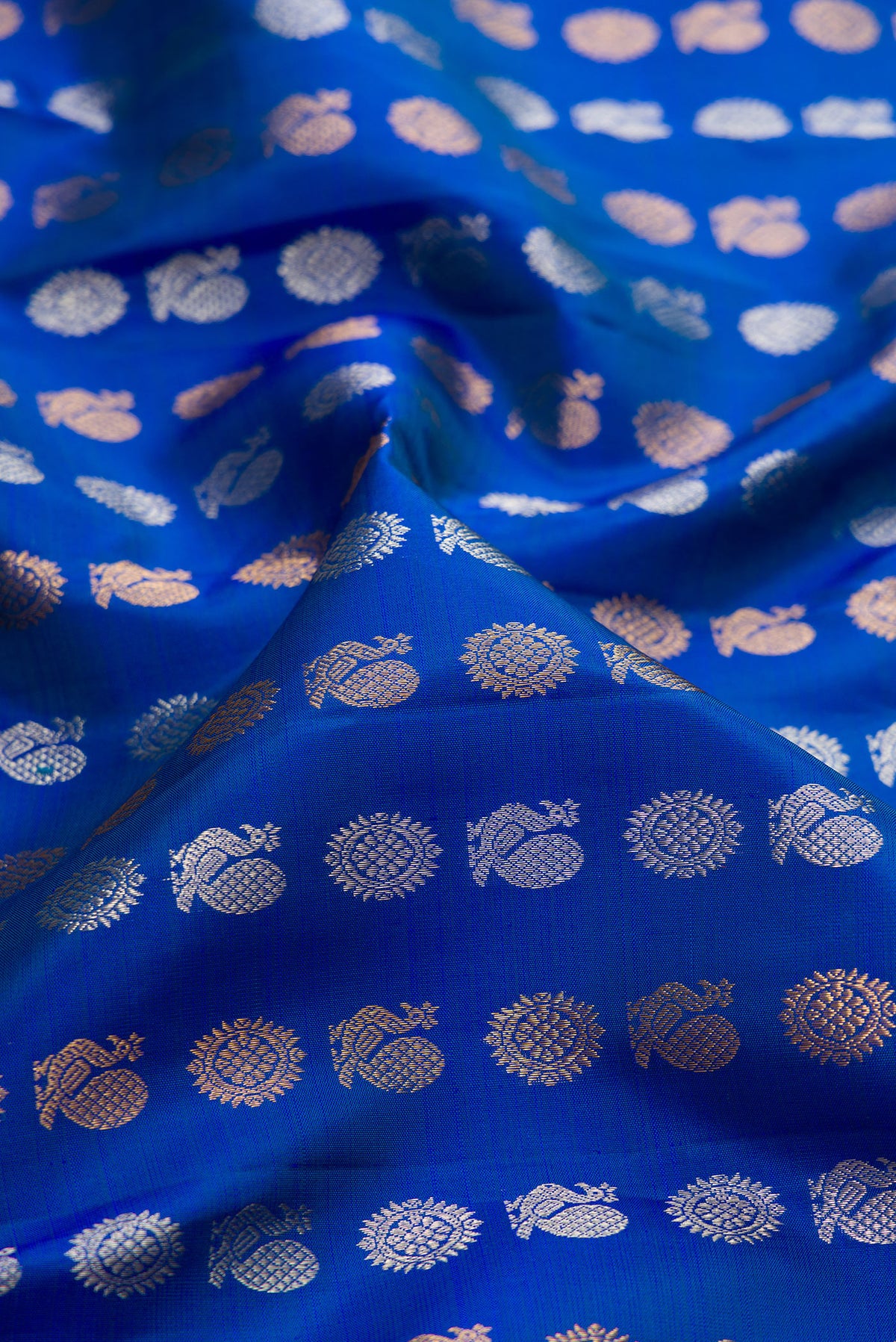 Close up of Royal Blue Kanjivaram Silk Saree with Zari Butta on the body and Zari Border.  displaying folds
