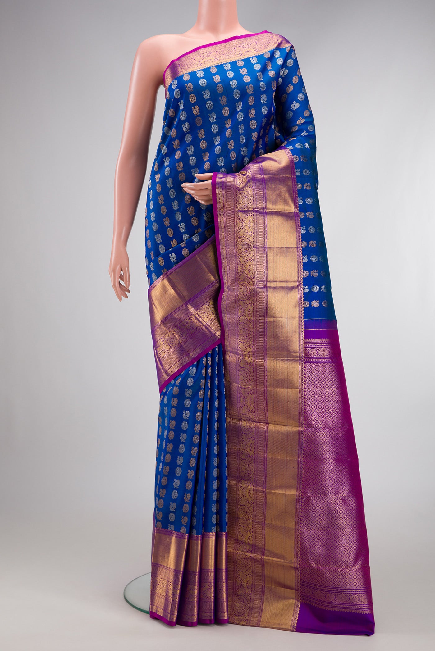 Royal Blue Kanjivaram Silk Saree with Zari Butta on the body and Zari Border.  displayed on a mannequin