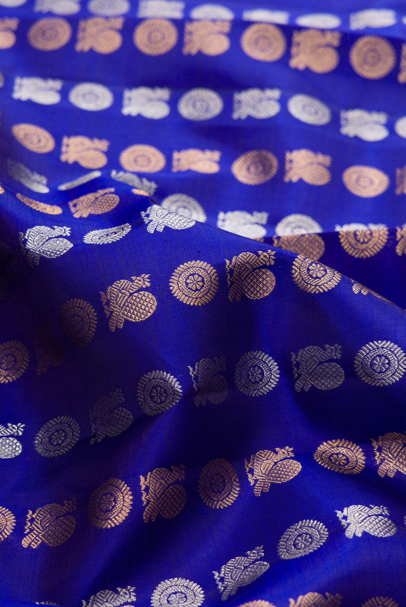 Close up of Navy Blue Dual Tone Kanjivaram Silk Saree with Zari Butta on the body and Zari Border.  displaying folds