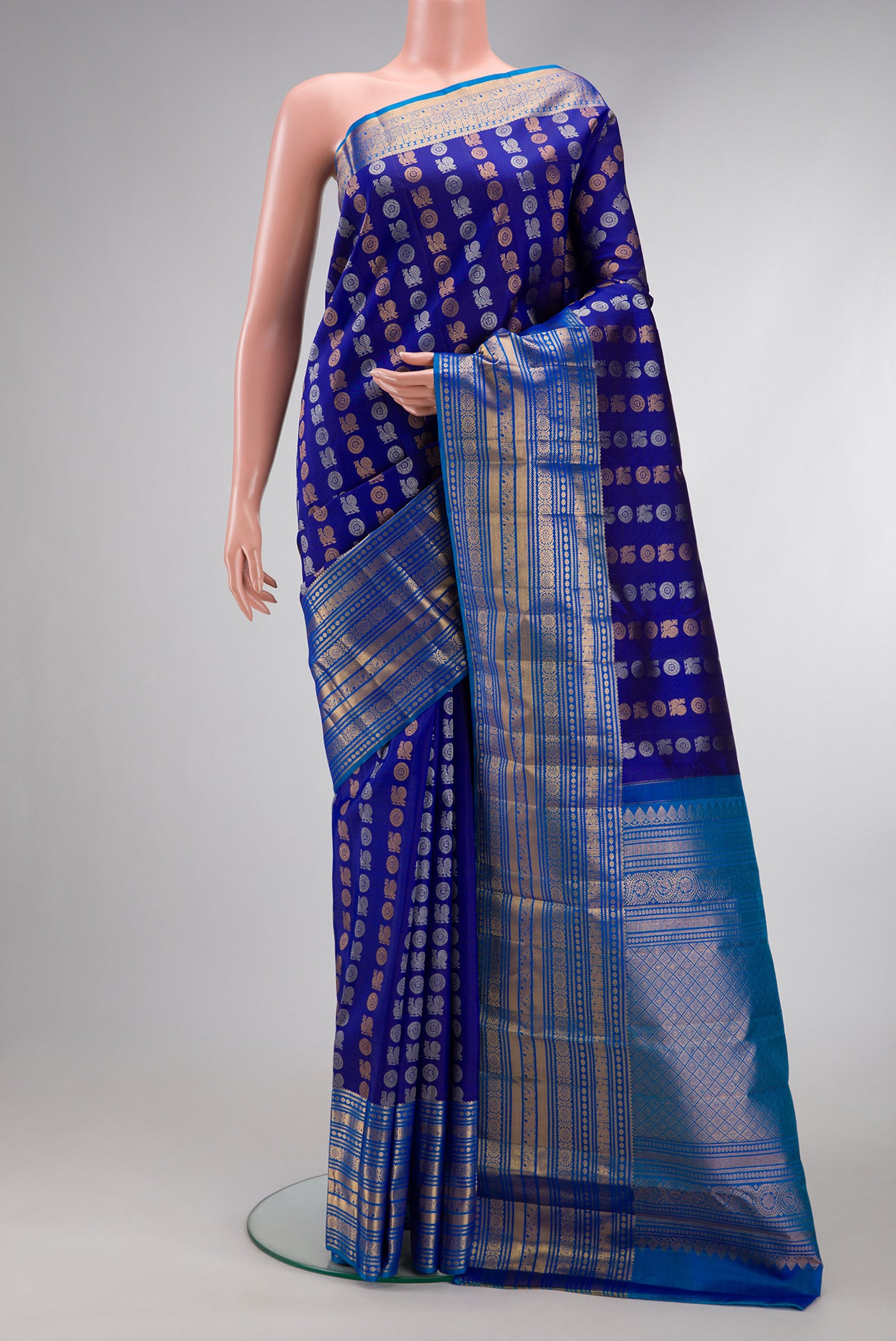 Navy Blue Dual Tone Kanjivaram Silk Saree with Zari Butta on the body and Zari Border.  displayed on a mannequin