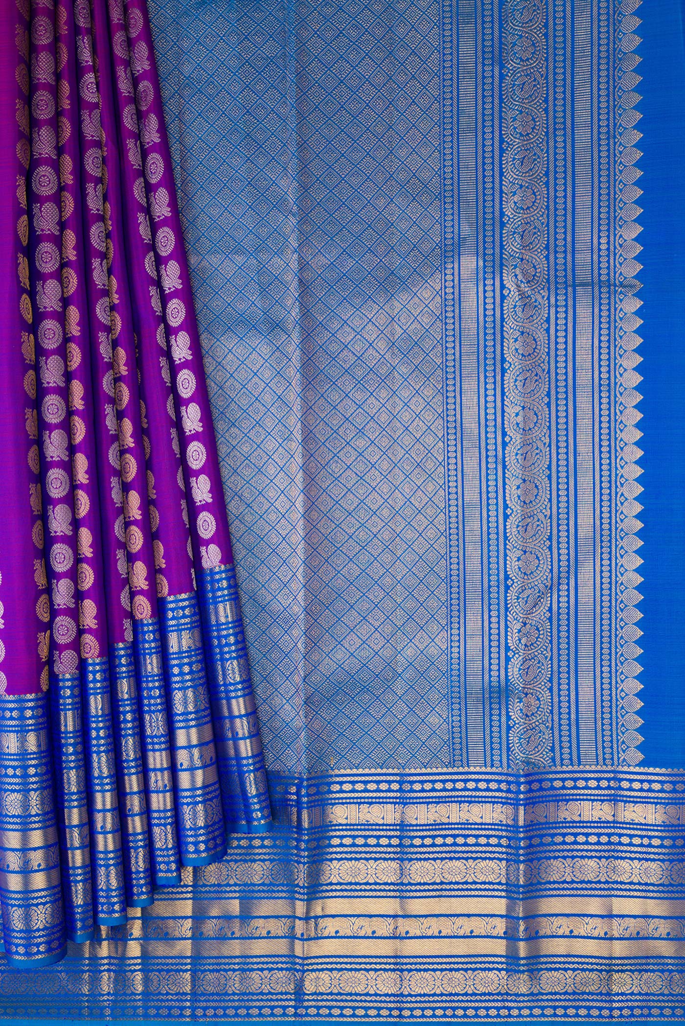 Pleats and pallu of Purple Kanjivaram Silk Saree with Zari Butta on the body and Zari Border. 