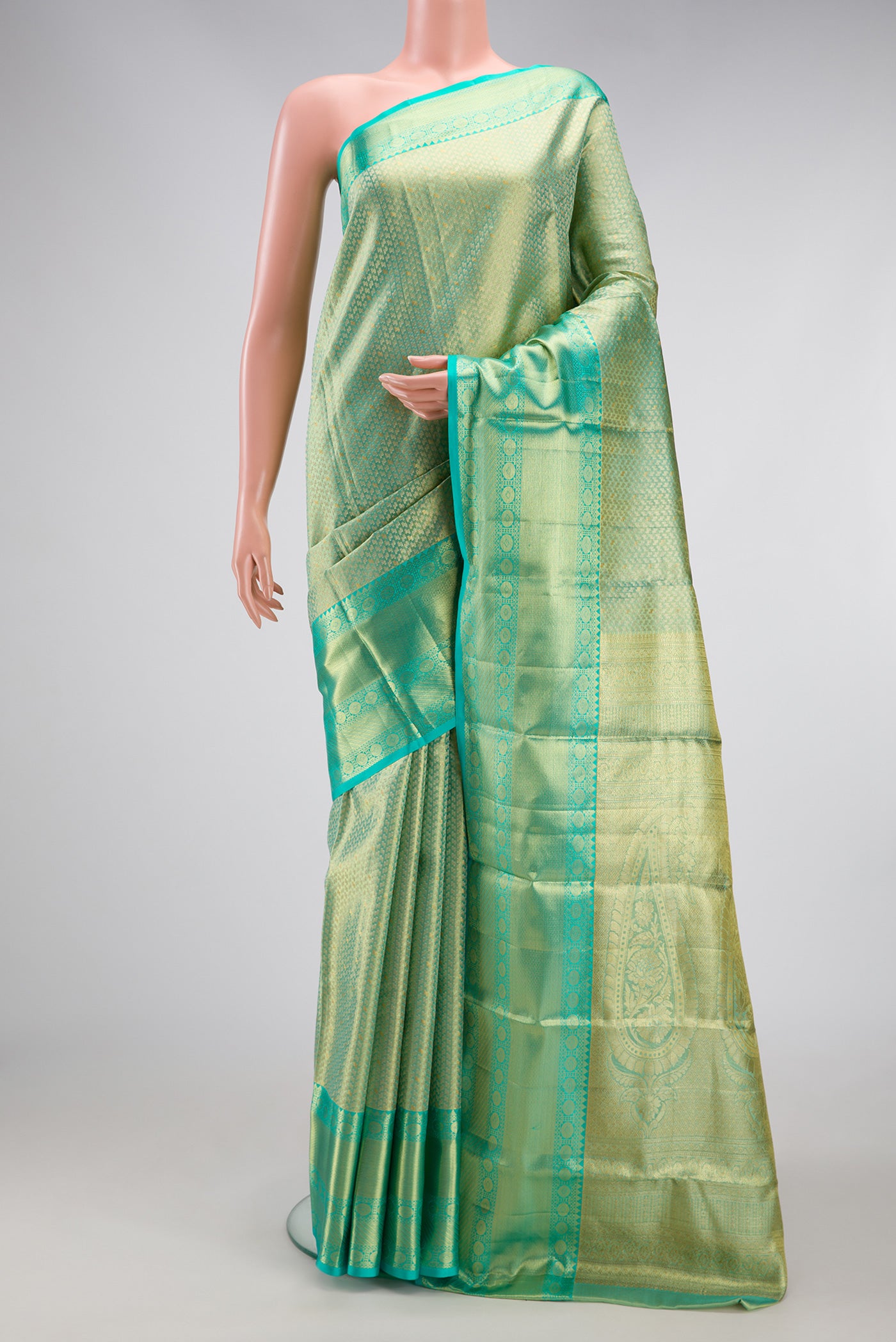 Light Green Dual Tone Kanchipuram Tissue Silk Saree with Zari Brocade on the body and Zari Border.  displayed on a mannequin