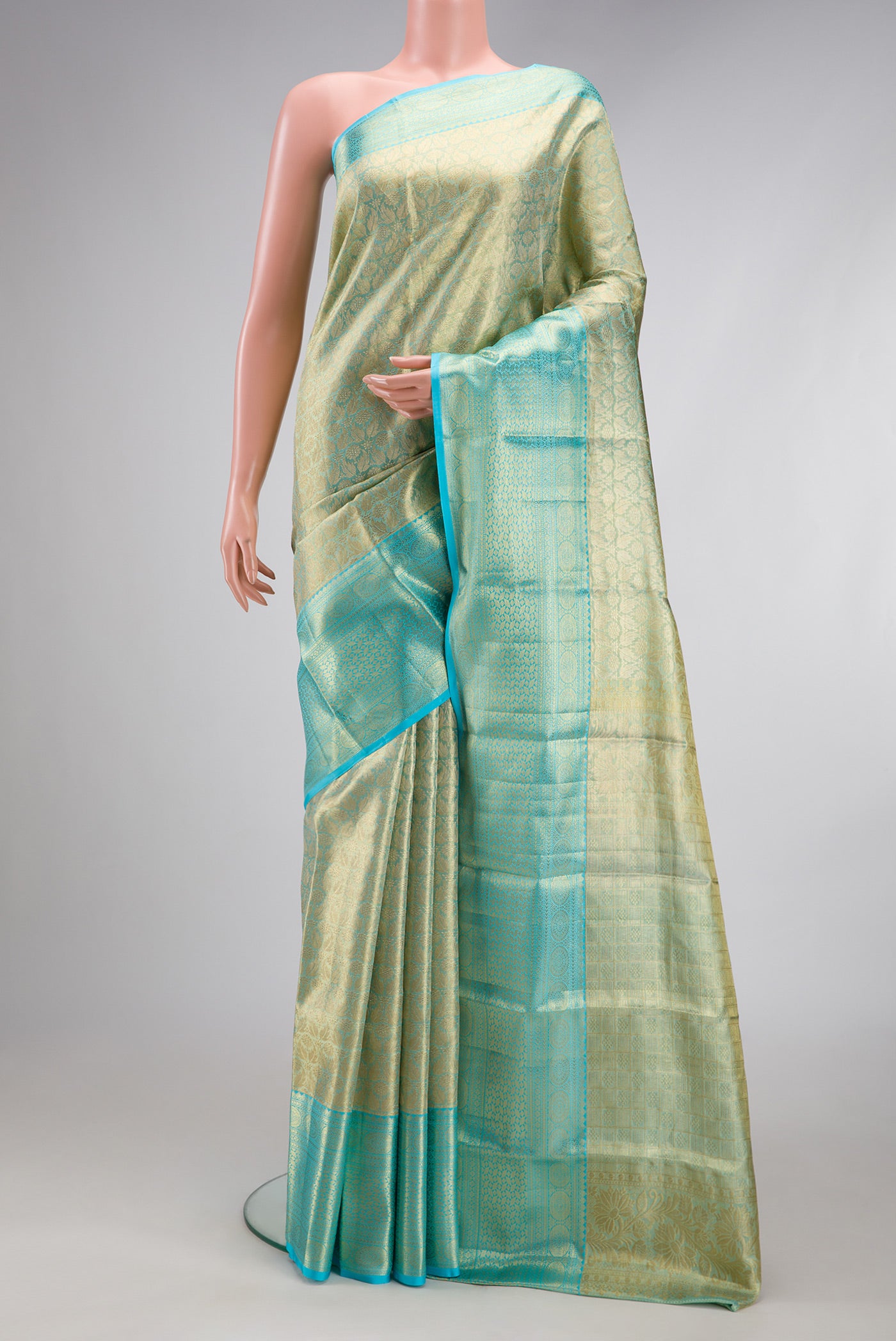 Sky Blue Dual Tone Kanchipuram Tissue Silk Saree with Zari Brocade on the body and Zari Border.  displayed on a mannequin