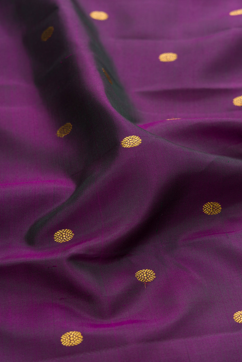Close up of Purple Kanjivaram Silk Saree with Zari Butta on the body and Zari Border.  displaying folds