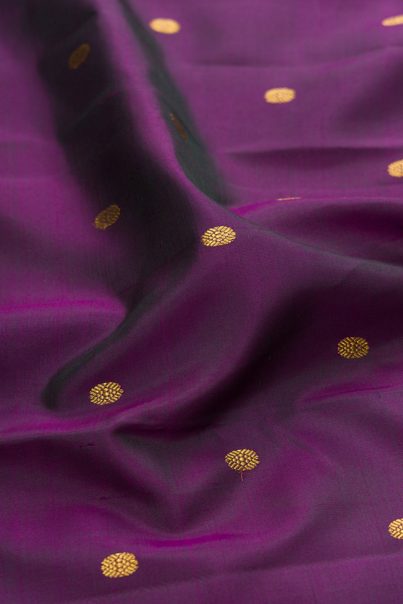 Close up of Purple Kanjivaram Silk Saree with Zari Butta on the body and Zari Border.  displaying folds