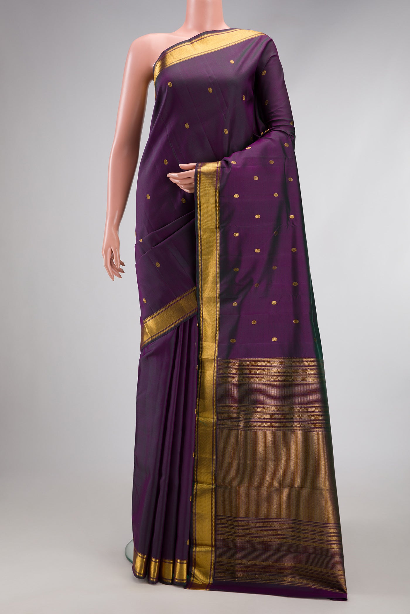 Purple Kanjivaram Silk Saree with Zari Butta on the body and Zari Border.  displayed on a mannequin
