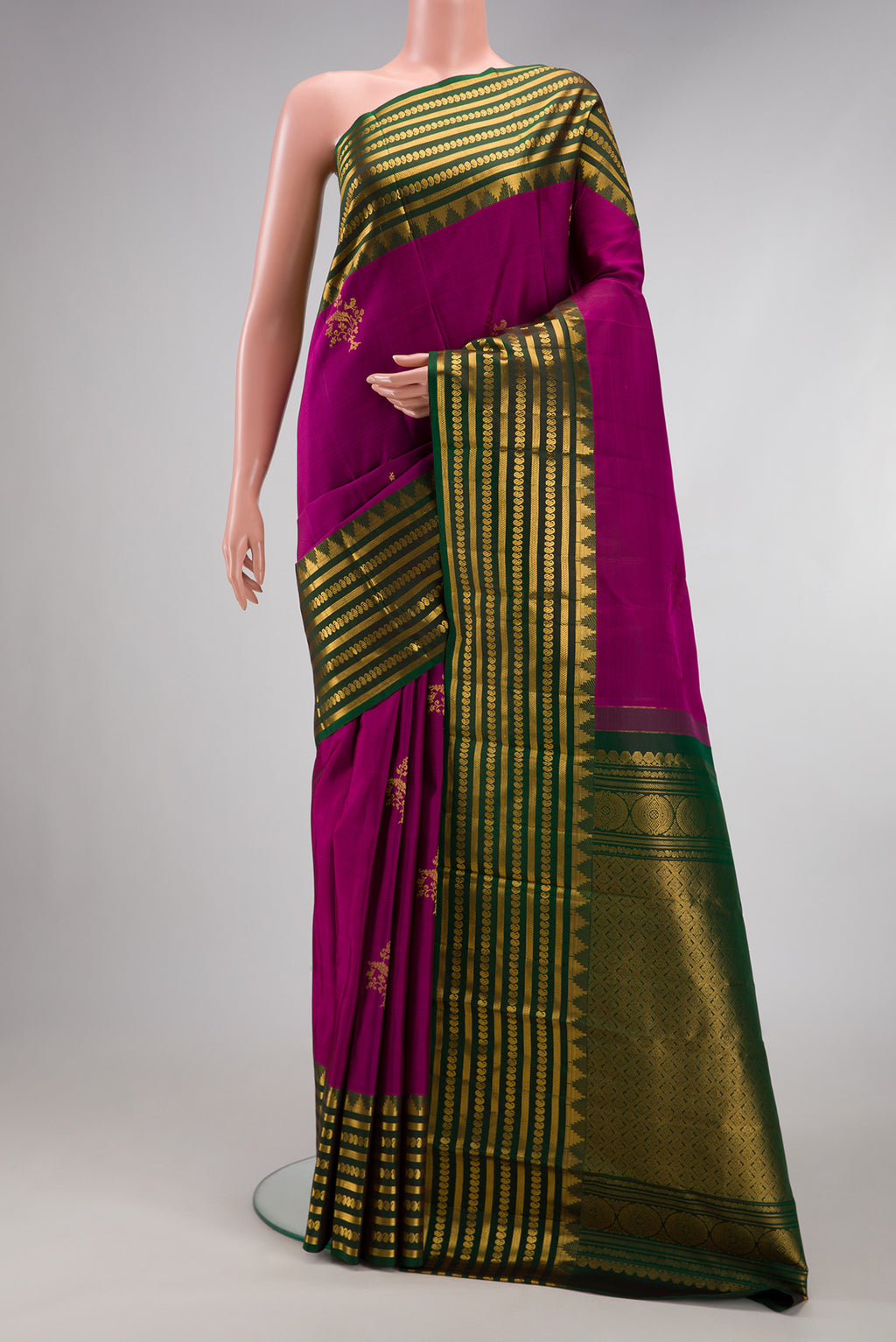 Magenta Kanchipuram Silk Saree with Zari Butta on the body and Fancy Border.  displayed on a mannequin
