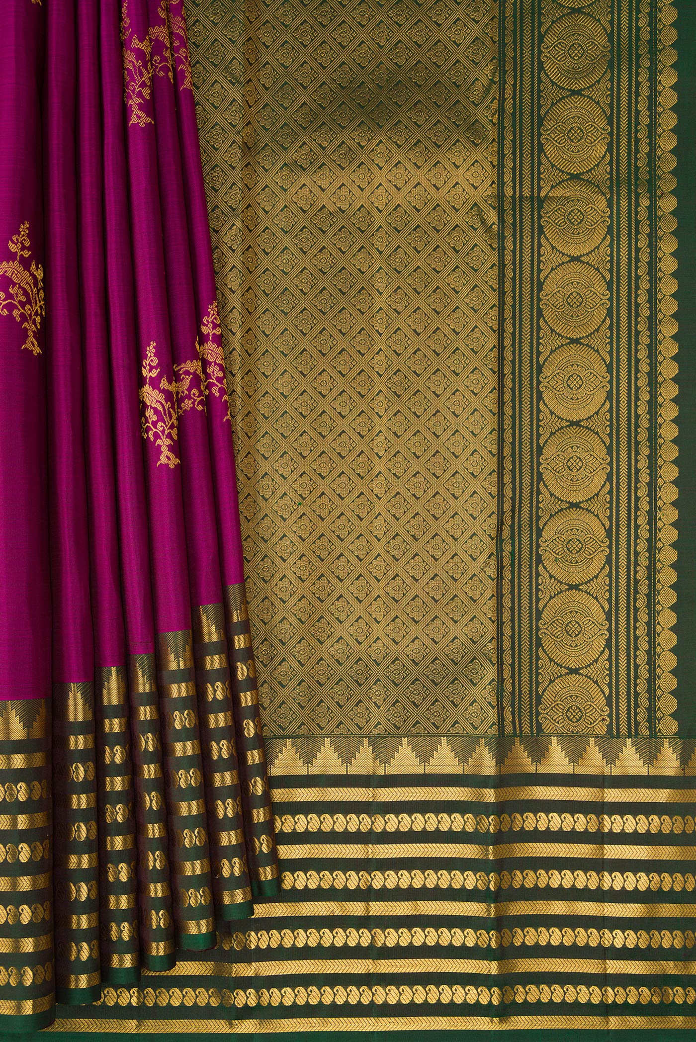 Pleats and pallu of Magenta Kanchipuram Silk Saree with Zari Butta on the body and Fancy Border. 