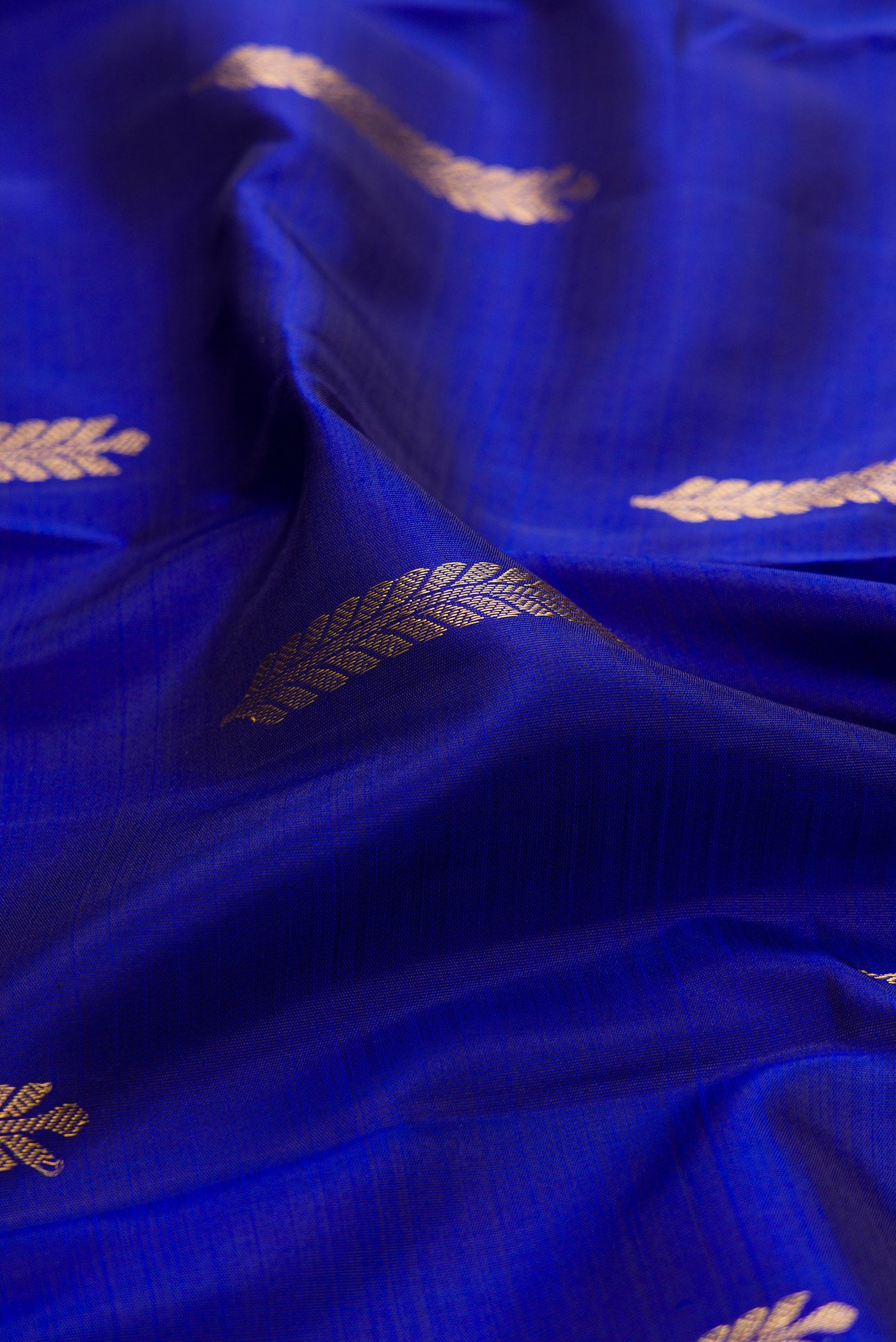 Close up of Navy Blue Kanjivaram Silk Saree with Zari Butta on the body and Temple Border.  displaying folds