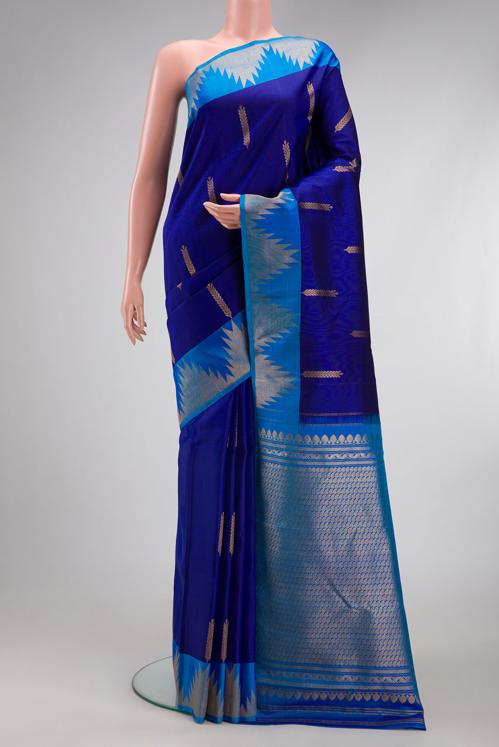 Navy Blue Kanjivaram Silk Saree with Zari Butta on the body and Temple Border.  displayed on a mannequin