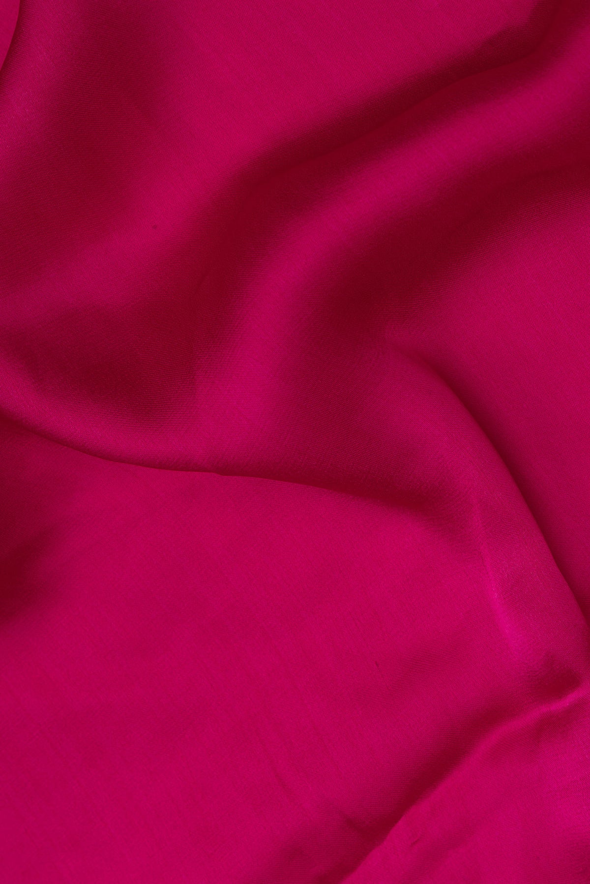 Close up of Dark Pink Crepe Saree with Plain Body and Embroidered Border.  displaying folds
