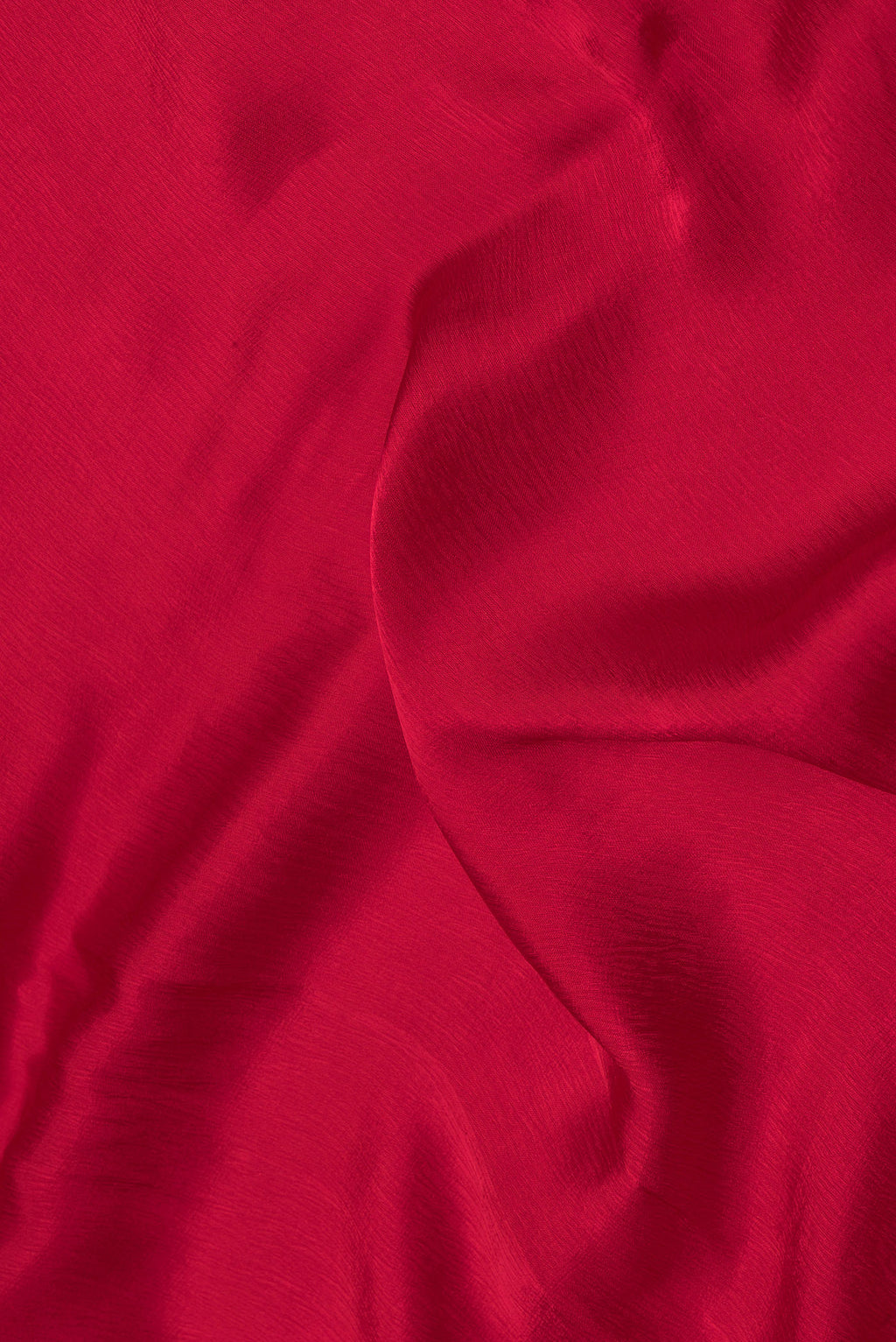 Close up of Red Satin Crepe Saree with Plain Body and Embroidery Border.  displaying folds