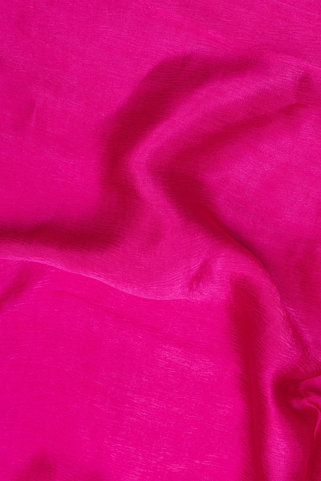 Close up of Dark Pink Crepe Saree with Plain Body and Embroidered Border.  displaying folds
