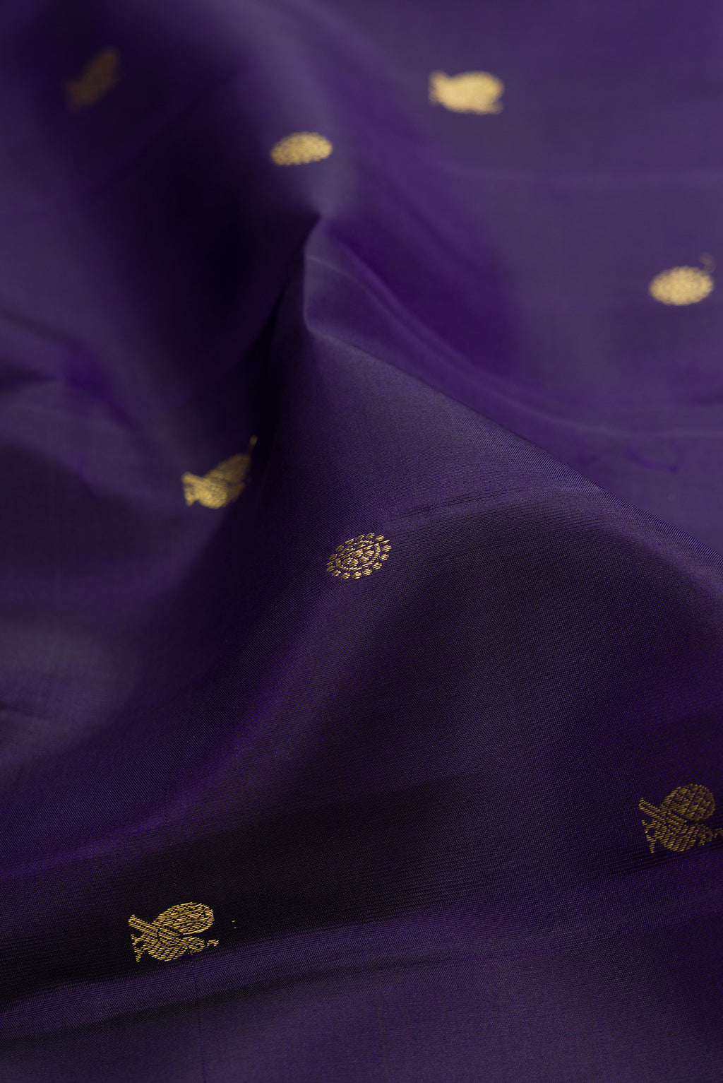 Close up of Navy Blue Kanchipuram Silk Saree with Zari Butta on the body and Zari Border.  displaying folds