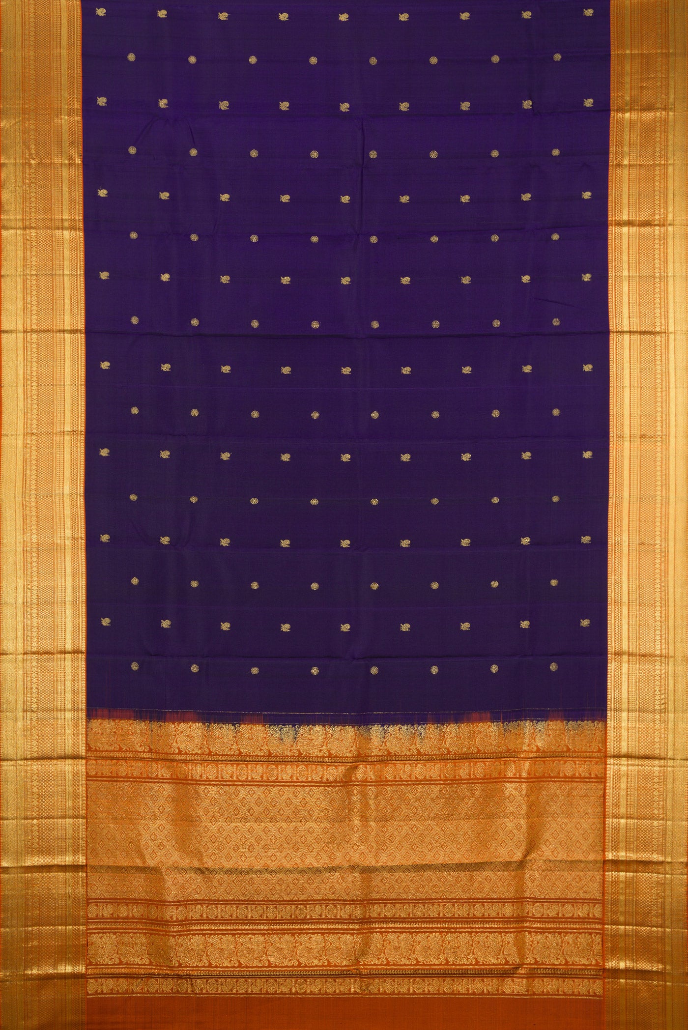 Flat view of Navy Blue Kanchipuram Silk Saree with Zari Butta on the body and Zari Border. 