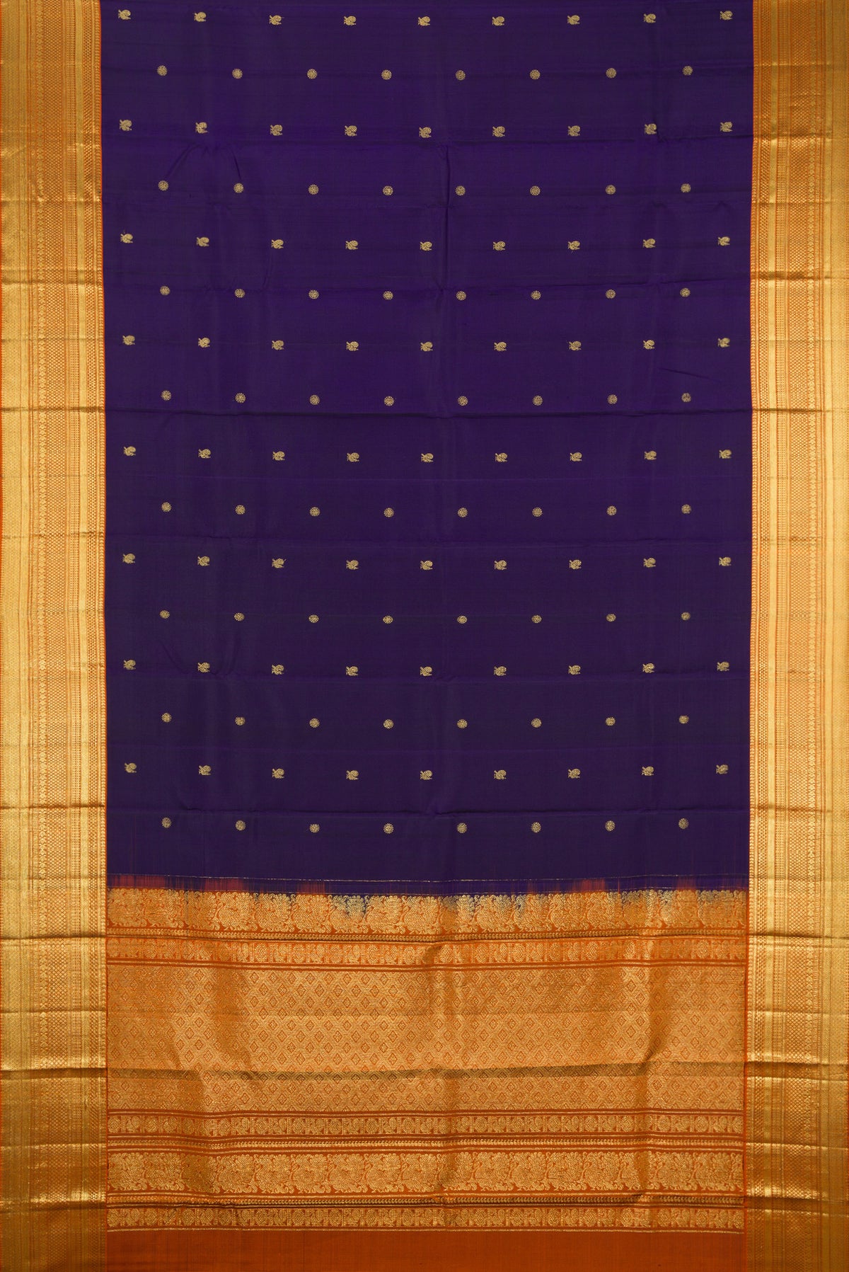 Flat view of Navy Blue Kanchipuram Silk Saree with Zari Butta on the body and Zari Border. 