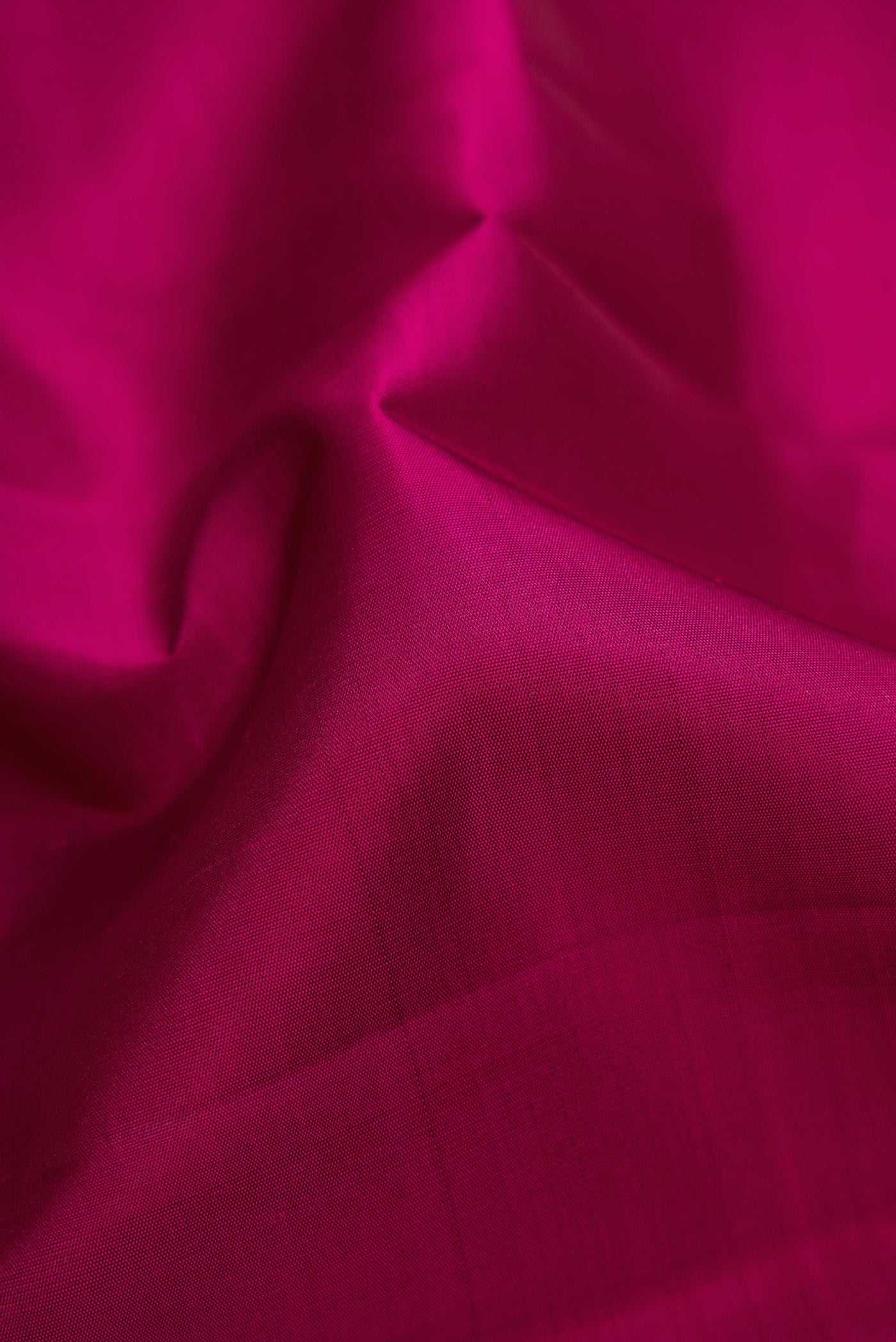 Close up of Magenta Dual Tone Kanchipuram Silk Saree with Plain Body and Temple Border.  displaying folds