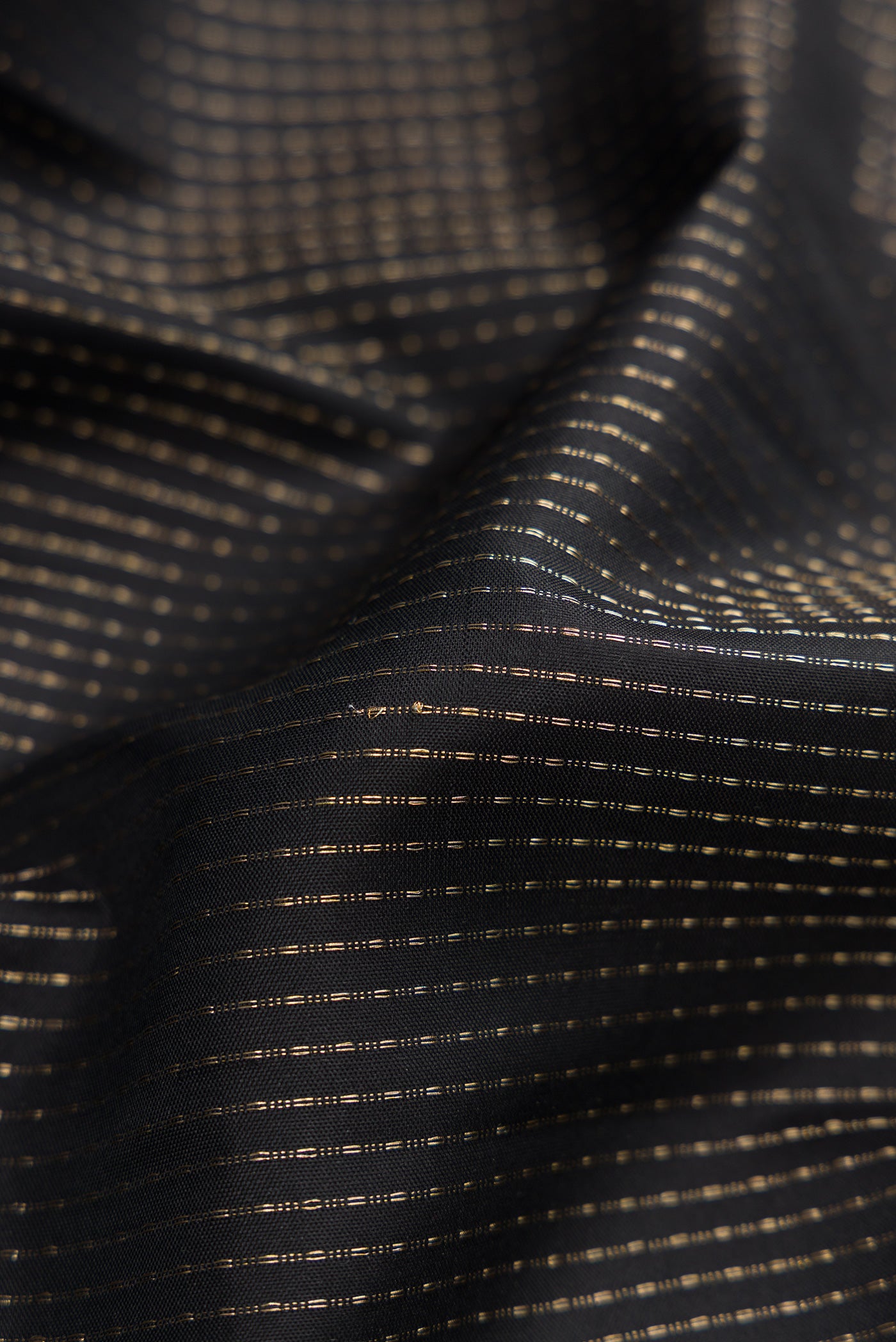 Close up of Black Soft Silk Saree with Stripes on the body and Zari Border.  displaying folds