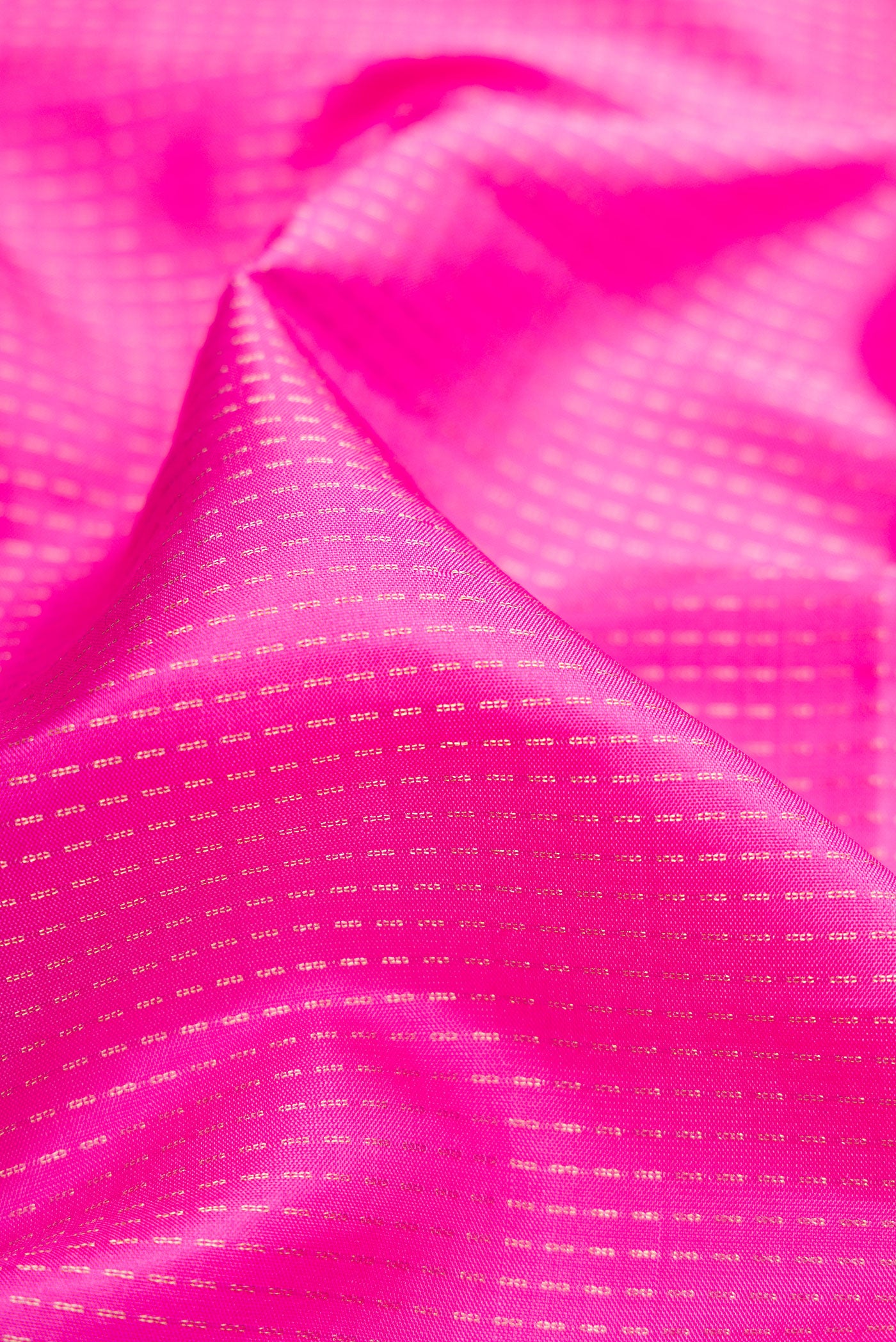 Close up of Pink Soft Silk Saree with Stripes on the body and Zari Border.  displaying folds