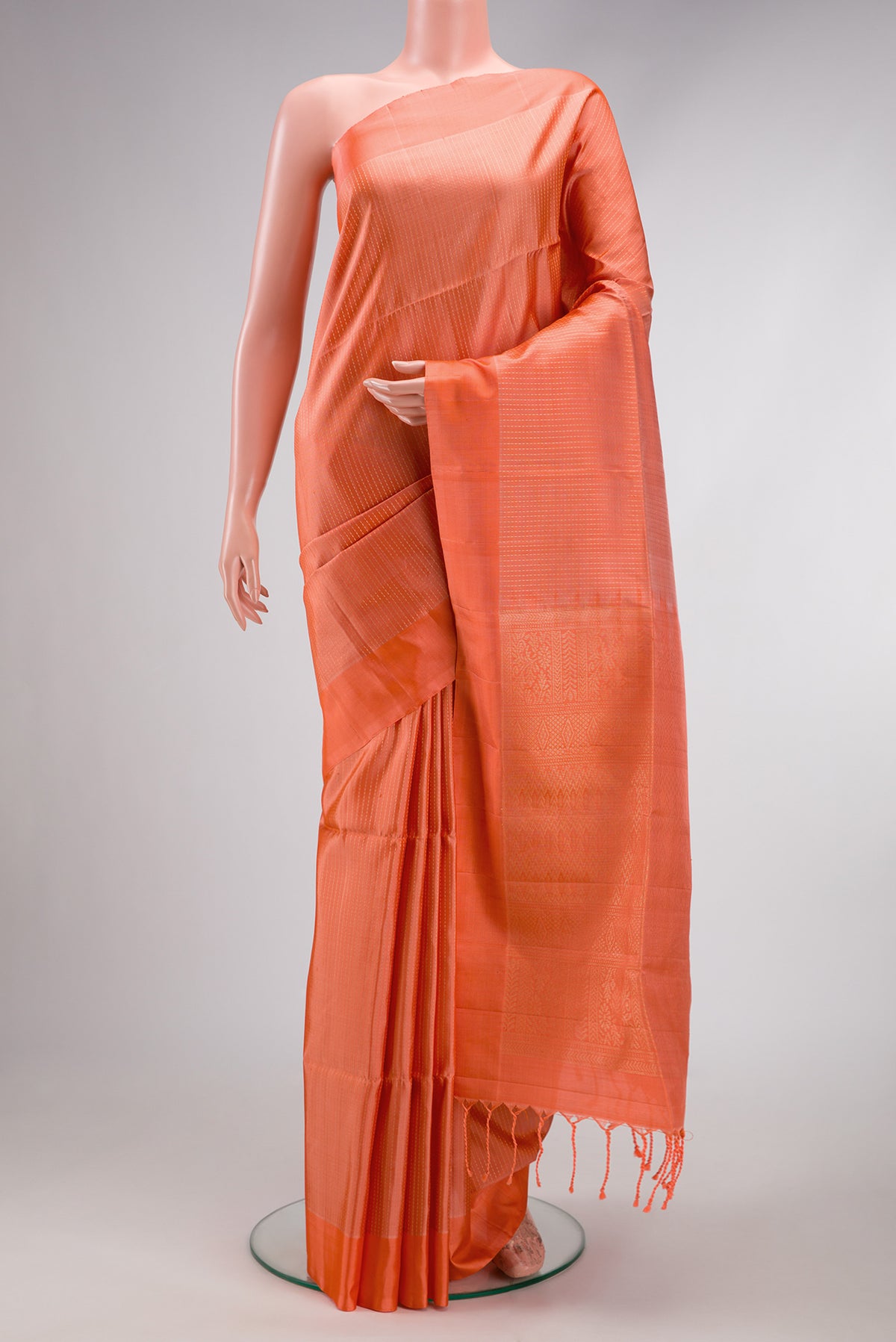Golden Peach Soft Silk Saree with Stripes on the body and Zari Border.  displayed on a mannequin