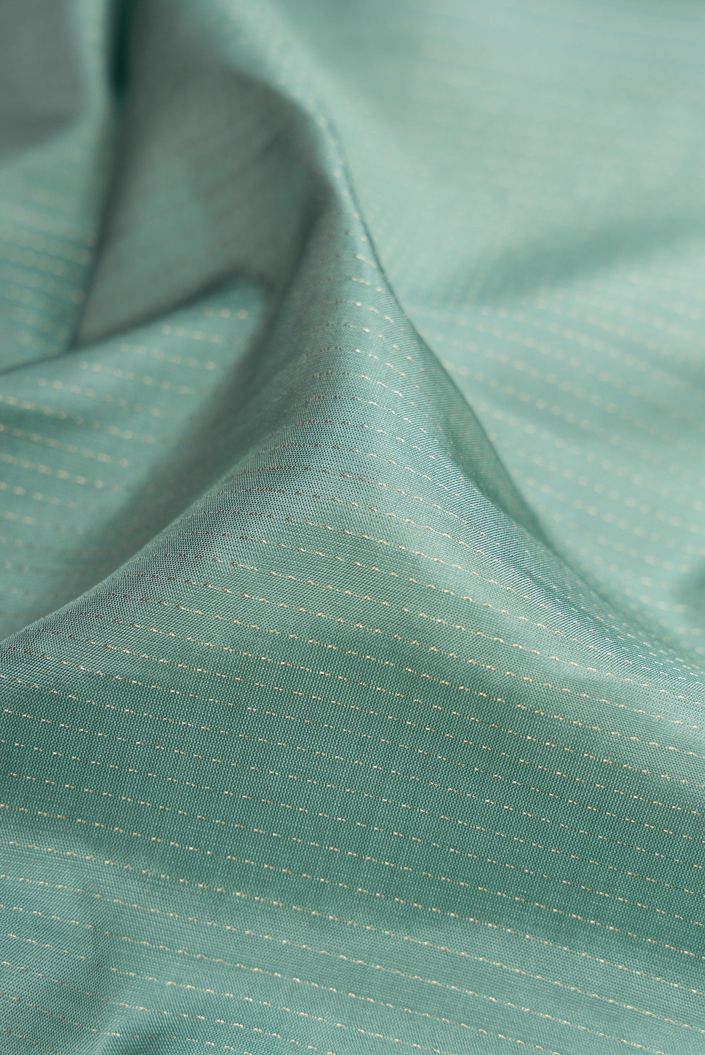 Close up of Grey Soft Silk Saree with Stripes on the body and Zari Border.  displaying folds