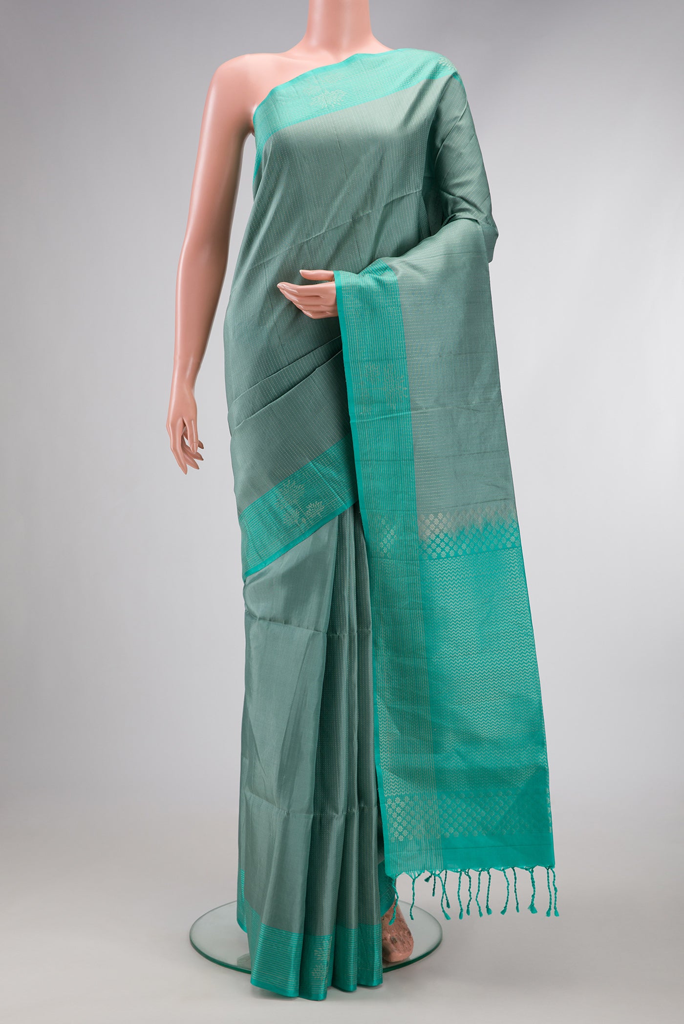Grey Soft Silk Saree with Stripes on the body and Zari Border.  displayed on a mannequin