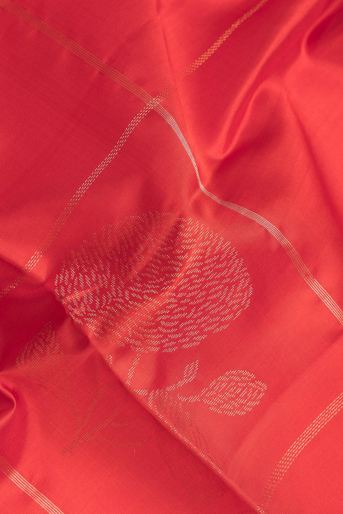Close up of Pure Silk Red Dual Tone Soft Saree with Zari Butta on the body and Zari Border.  displaying folds