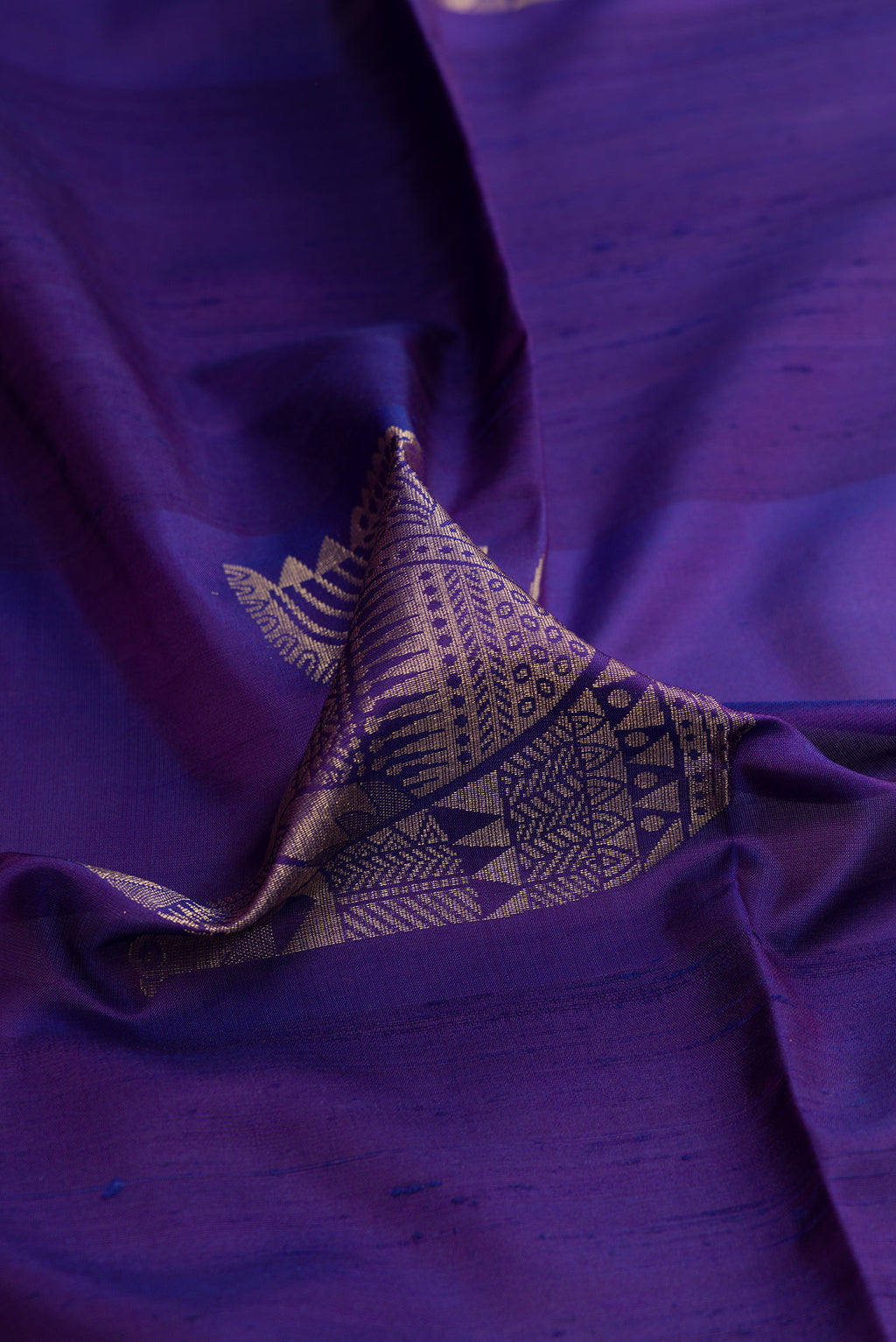 Close up of Dark Blue Soft Silk Saree with Zari Butta on the body and Without Border.  displaying folds