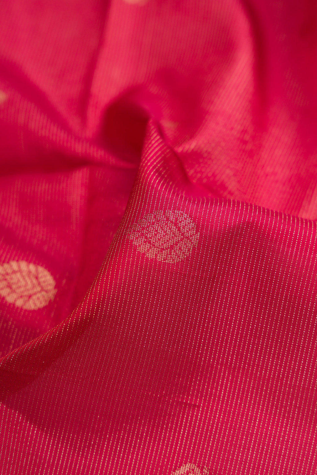 Close up of Maroon Dual Tone Soft Silk Saree with Zari Butta on the body and Plain Border.  displaying folds