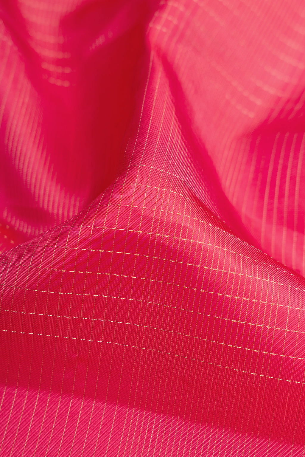 Close up of Pink Dual Tone Soft Silk Saree with Checked design on the body and Fancy Border.  displaying folds
