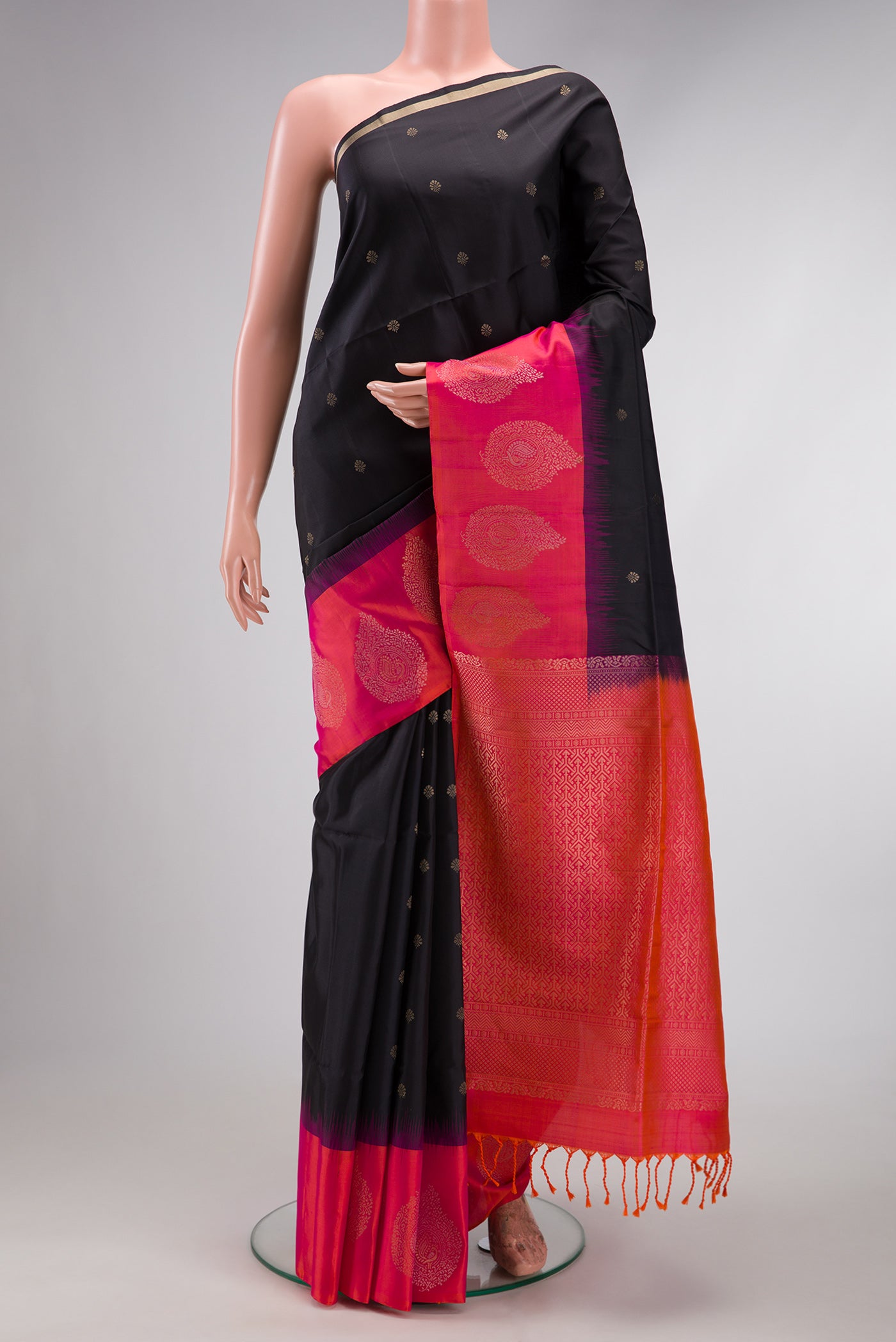 Black Soft Silk Saree with Zari Butta on the body and Fancy Border.  displayed on a mannequin