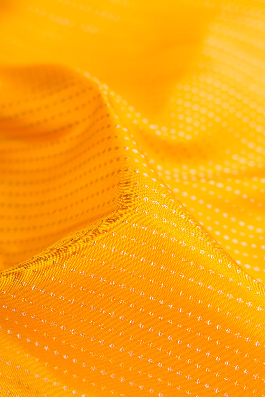 Close up of Mustard Soft Silk Saree with Stripes on the body and Zari Border.  displaying folds