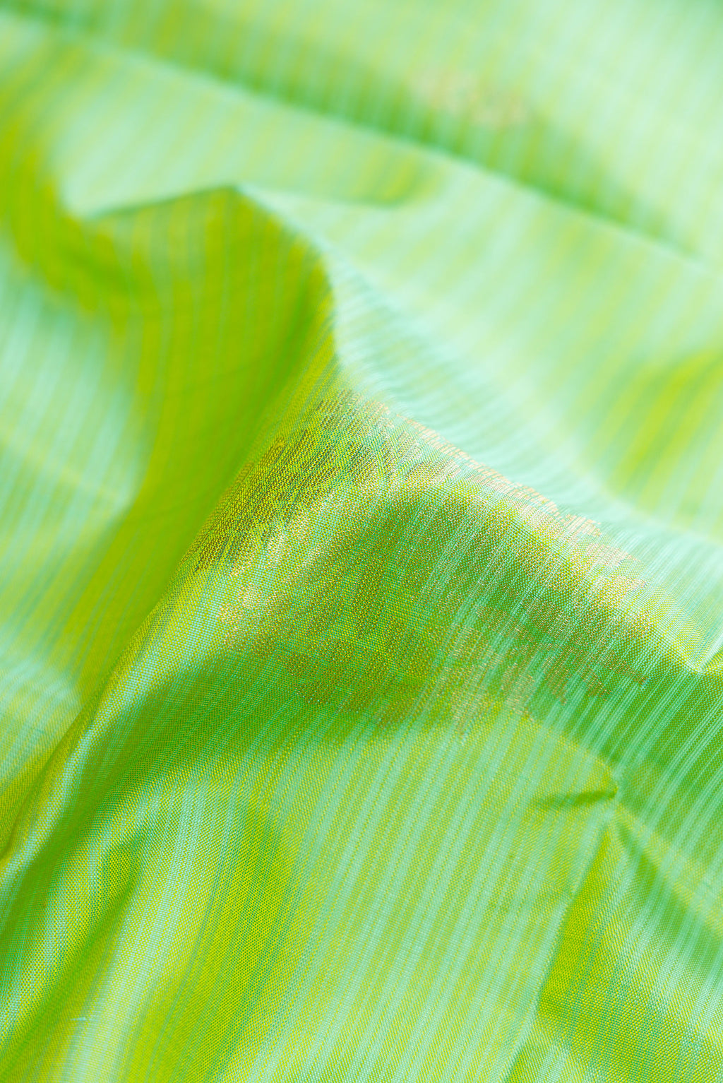 Close up of Beige and Off White Dual Tone Soft Silk Saree with Stripes on the body and Zari Border.  displaying folds