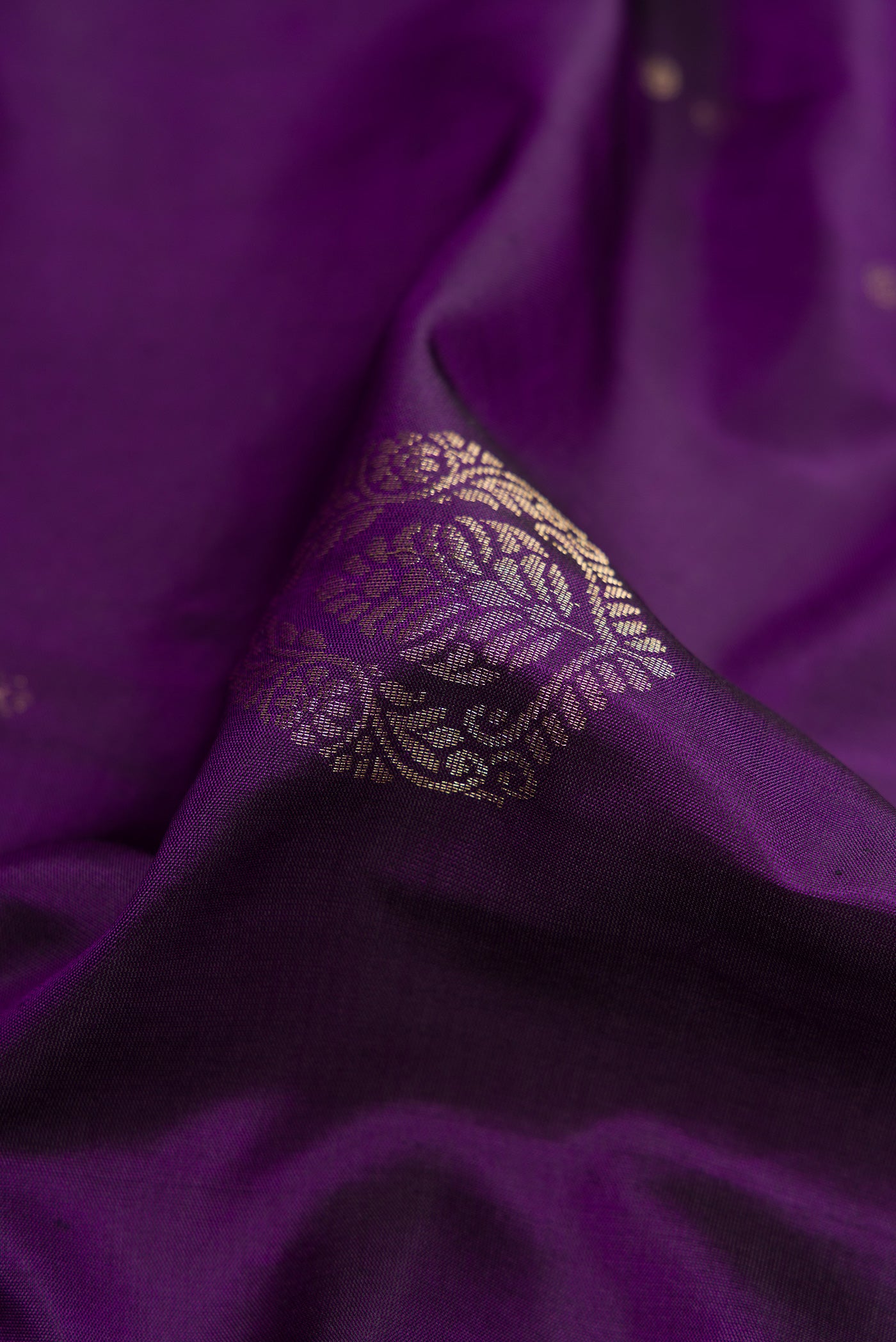 Close up of Violet Soft Silk Saree with Zari Butta on the body and Zari Border.  displaying folds