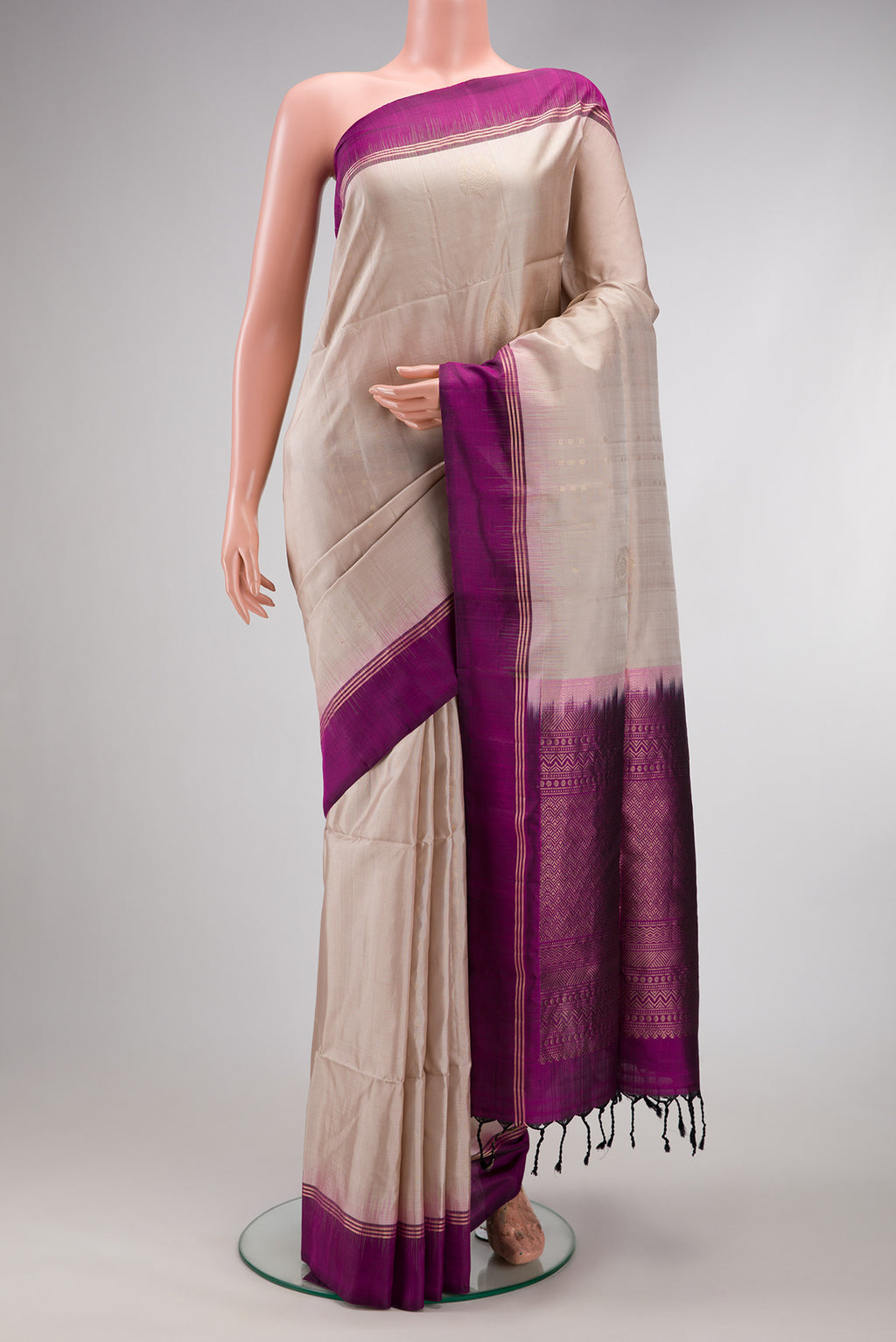 Beige Soft Silk Saree with Zari Butta on the body and Zari Border.  displayed on a mannequin