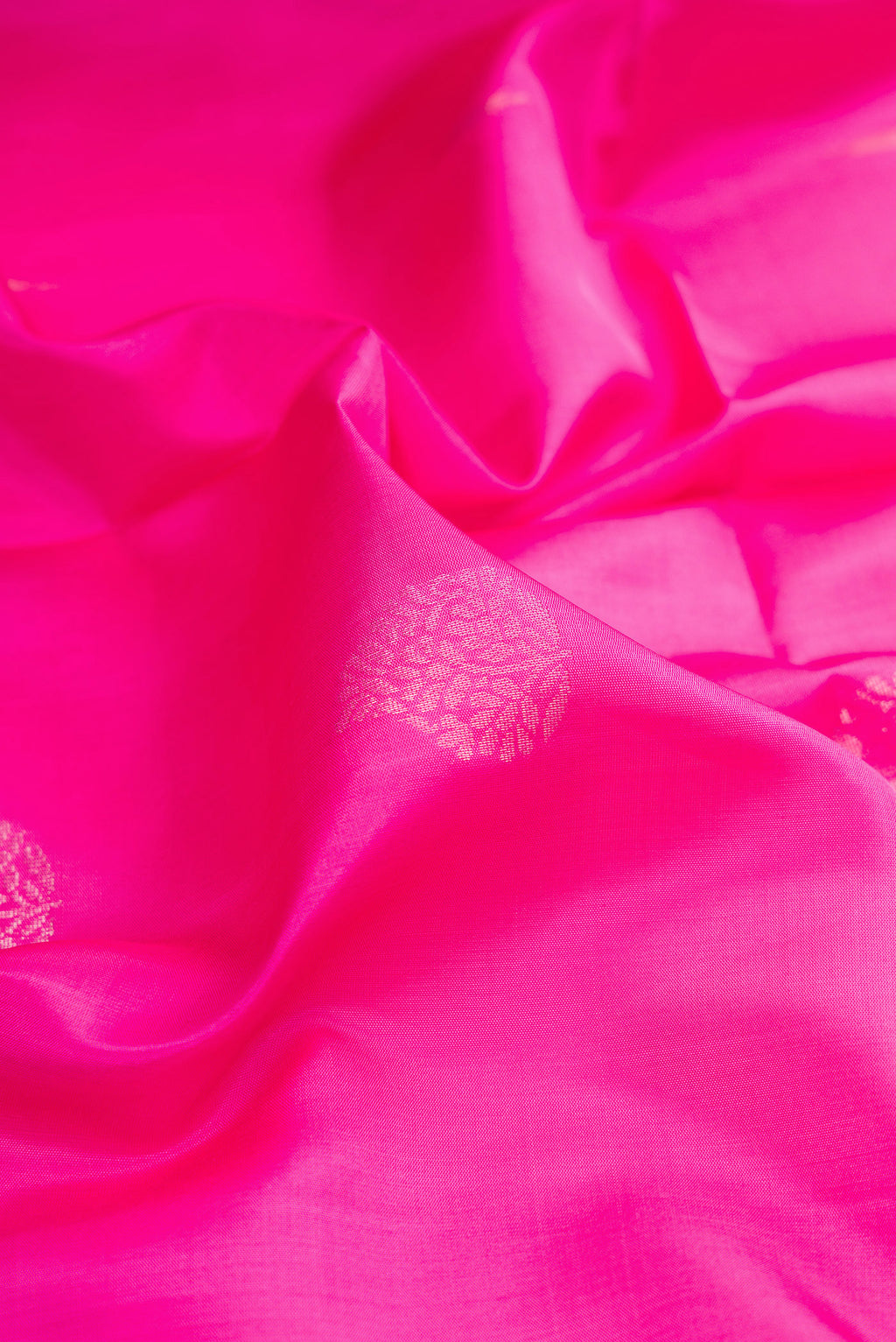 Close up of Pink Soft Silk Saree with Zari Butta on the body and Zari Border.  displaying folds