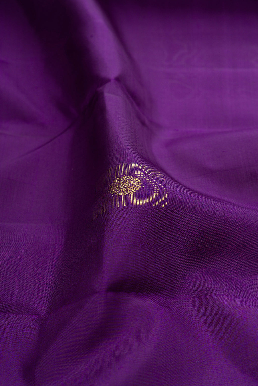 Close up of Pure Silk Pure Zari Violet Kanjivaram Saree with Zari Butta on the body and Without Border.  displaying folds