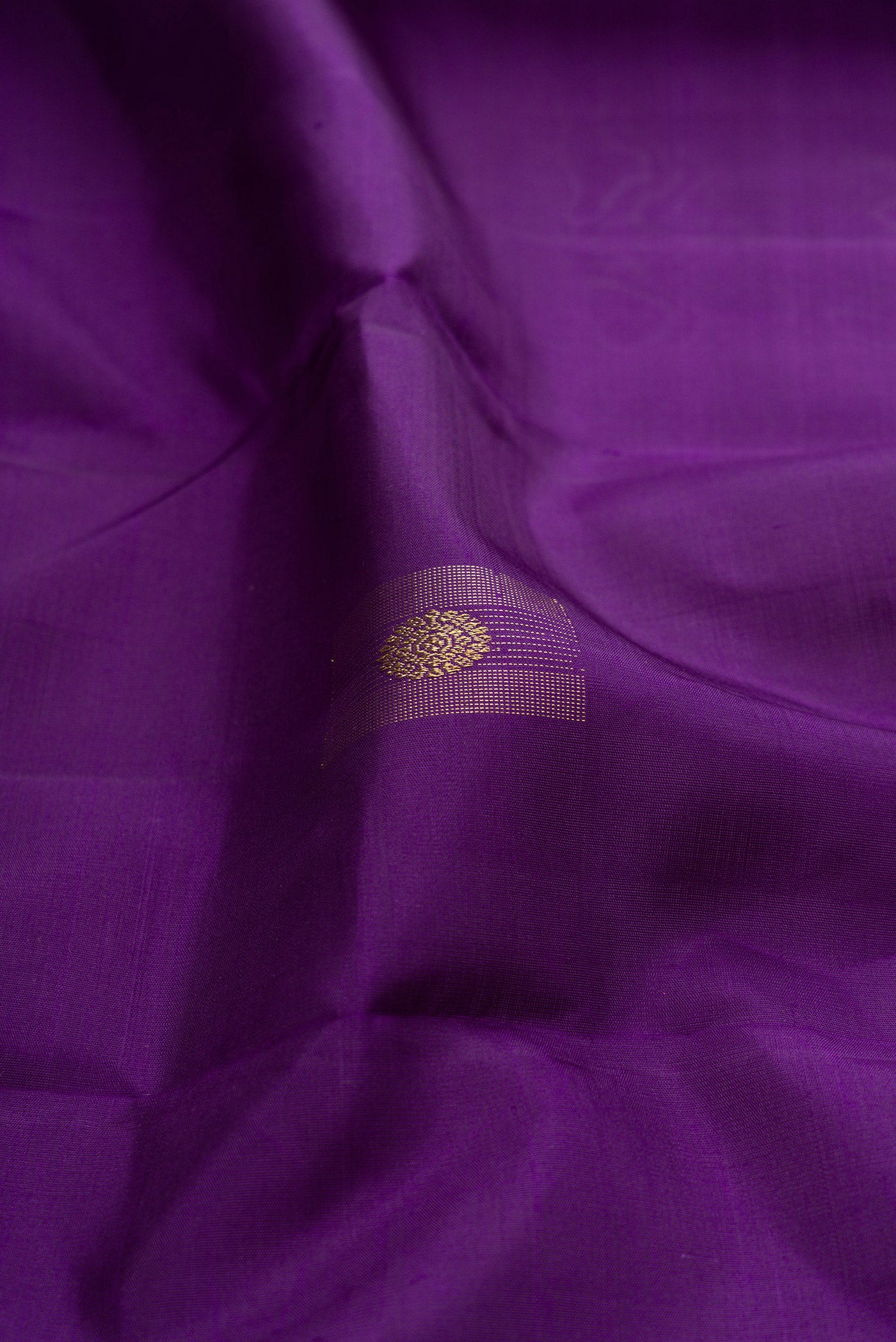Close up of Pure Silk Pure Zari Violet Kanjivaram Saree with Zari Butta on the body and Without Border.  displaying folds