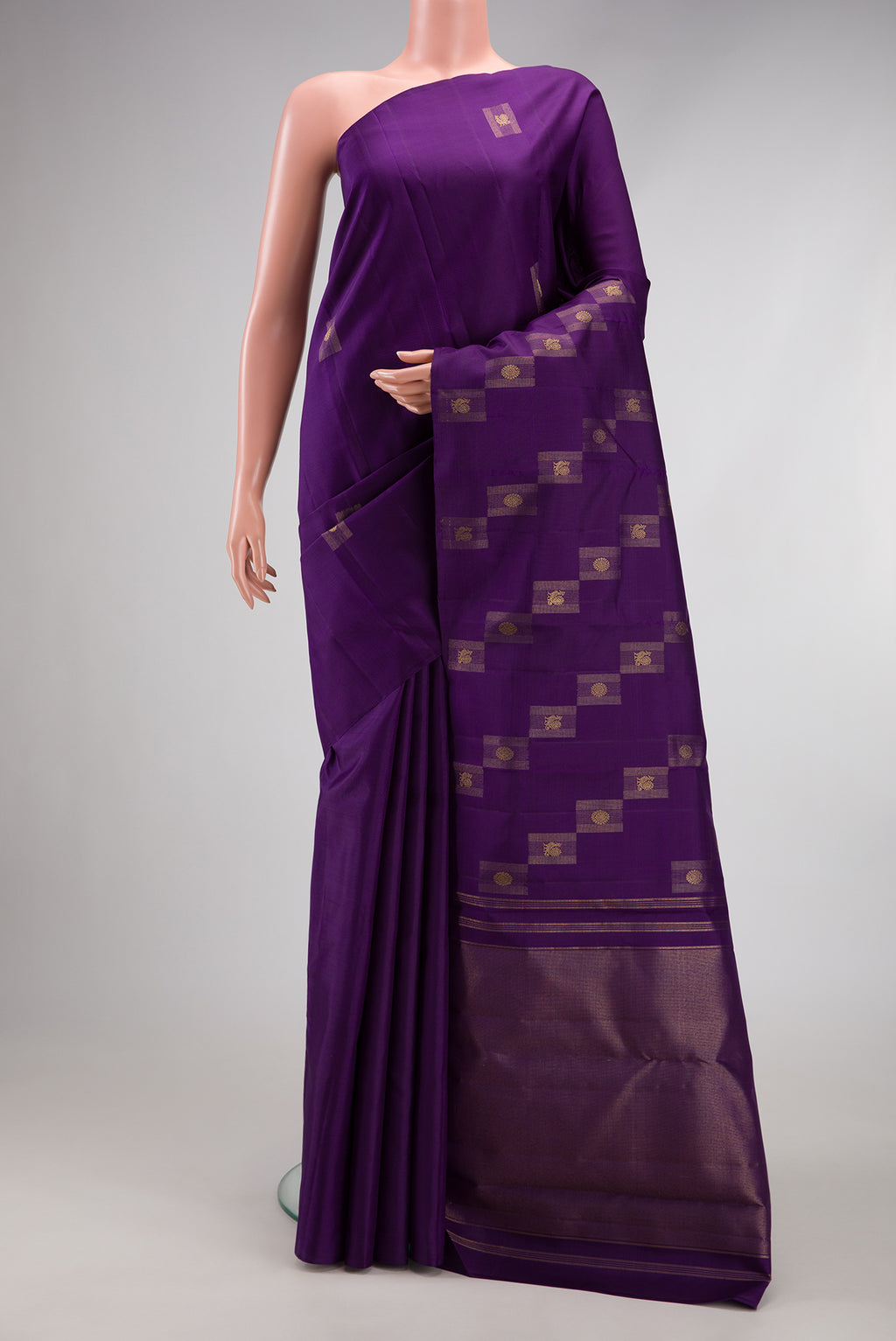 Pure Silk Pure Zari Violet Kanjivaram Saree with Zari Butta on the body and Without Border.  displayed on a mannequin