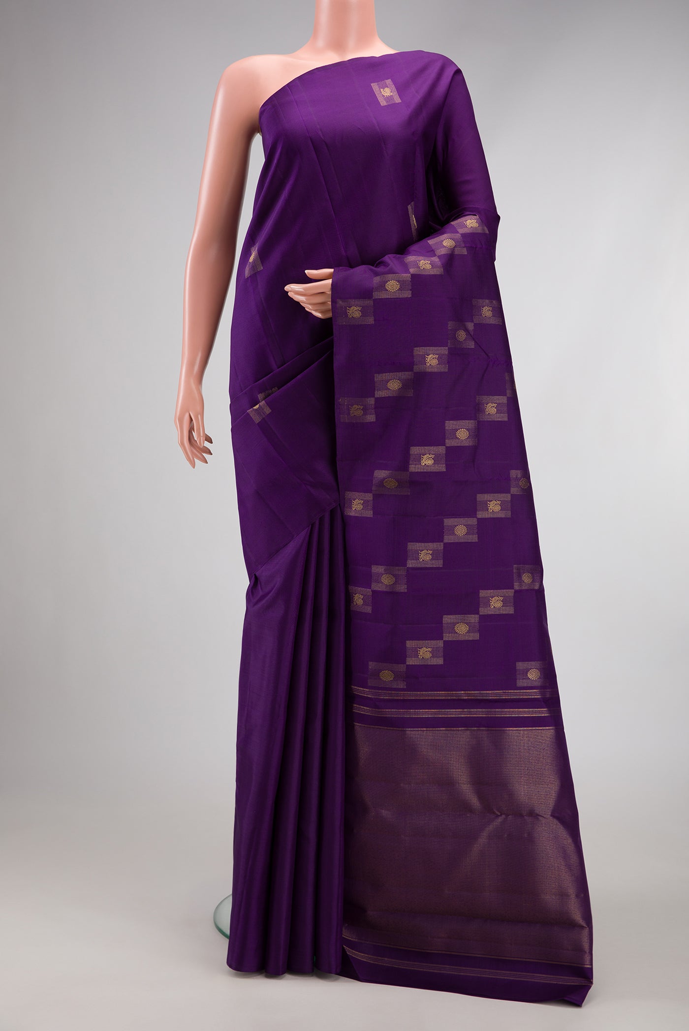 Pure Silk Pure Zari Violet Kanjivaram Saree with Zari Butta on the body and Without Border.  displayed on a mannequin