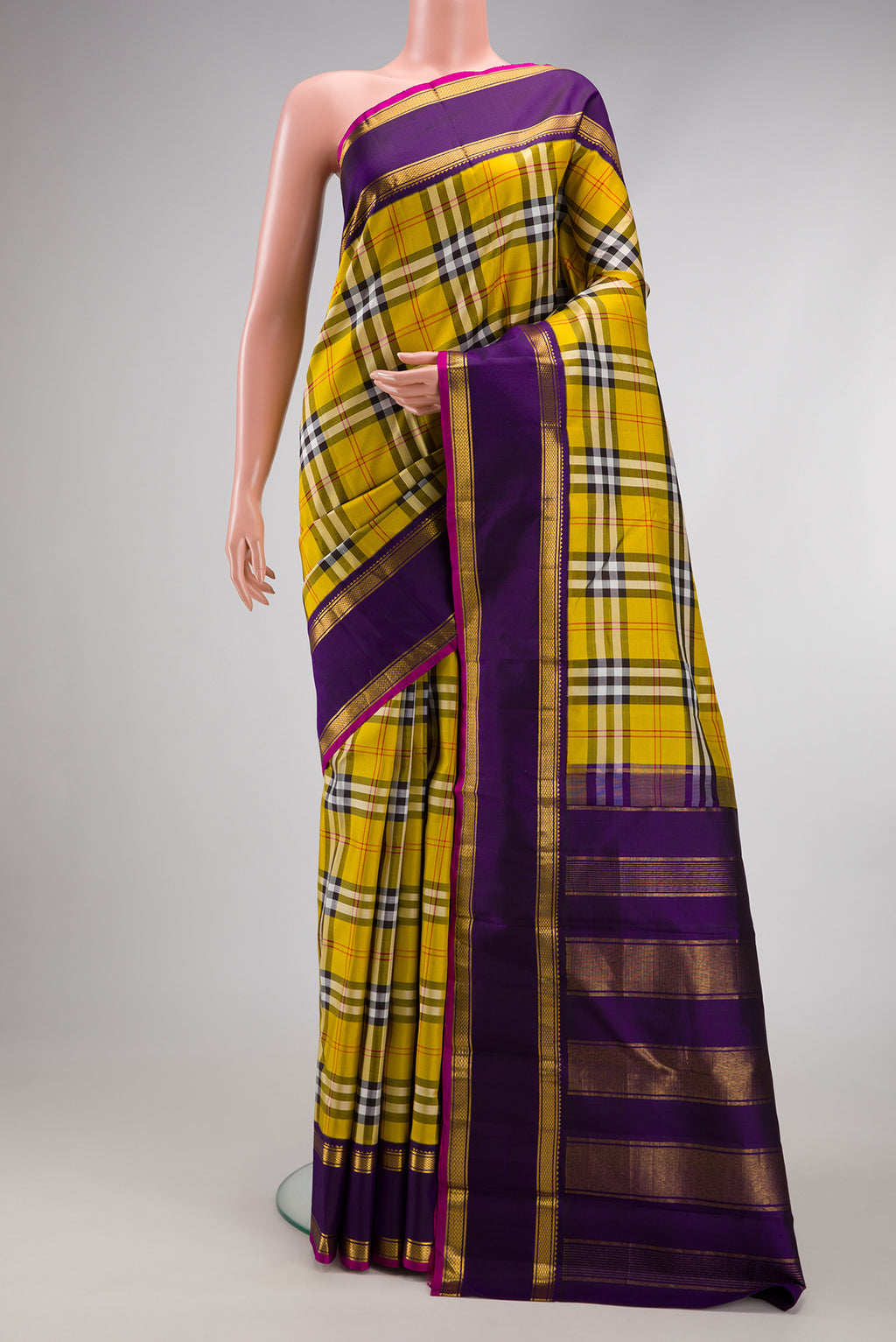 Pure Silk Pure Zari Yellow Kanjivaram Saree with Checked design on the body and Zari Border.  displayed on a mannequin