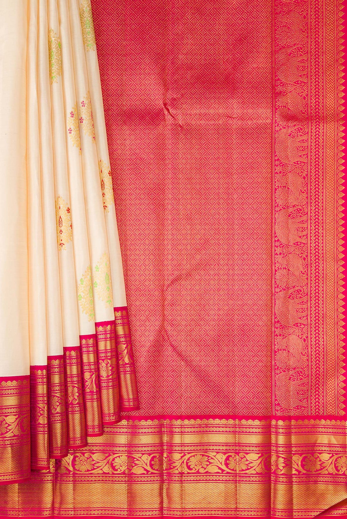 Pleats and pallu of Off White Kanchipuram Silk Saree with Zari And Thread Butta on the body and Zari Border. 